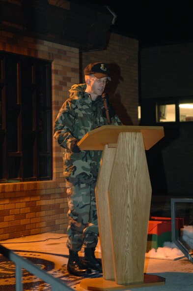 Chaplain, Captain Rolf Holmquist, 28th Bomb Wing, Dec. 11, prays before the annual Christmas tree lighting ceremony.  Many Airmen and their families withstood the bitter cold to watch the tree lighting ceremony. (U.S. Air Force photo / Airman 1st Class Anthony Sanchelli)