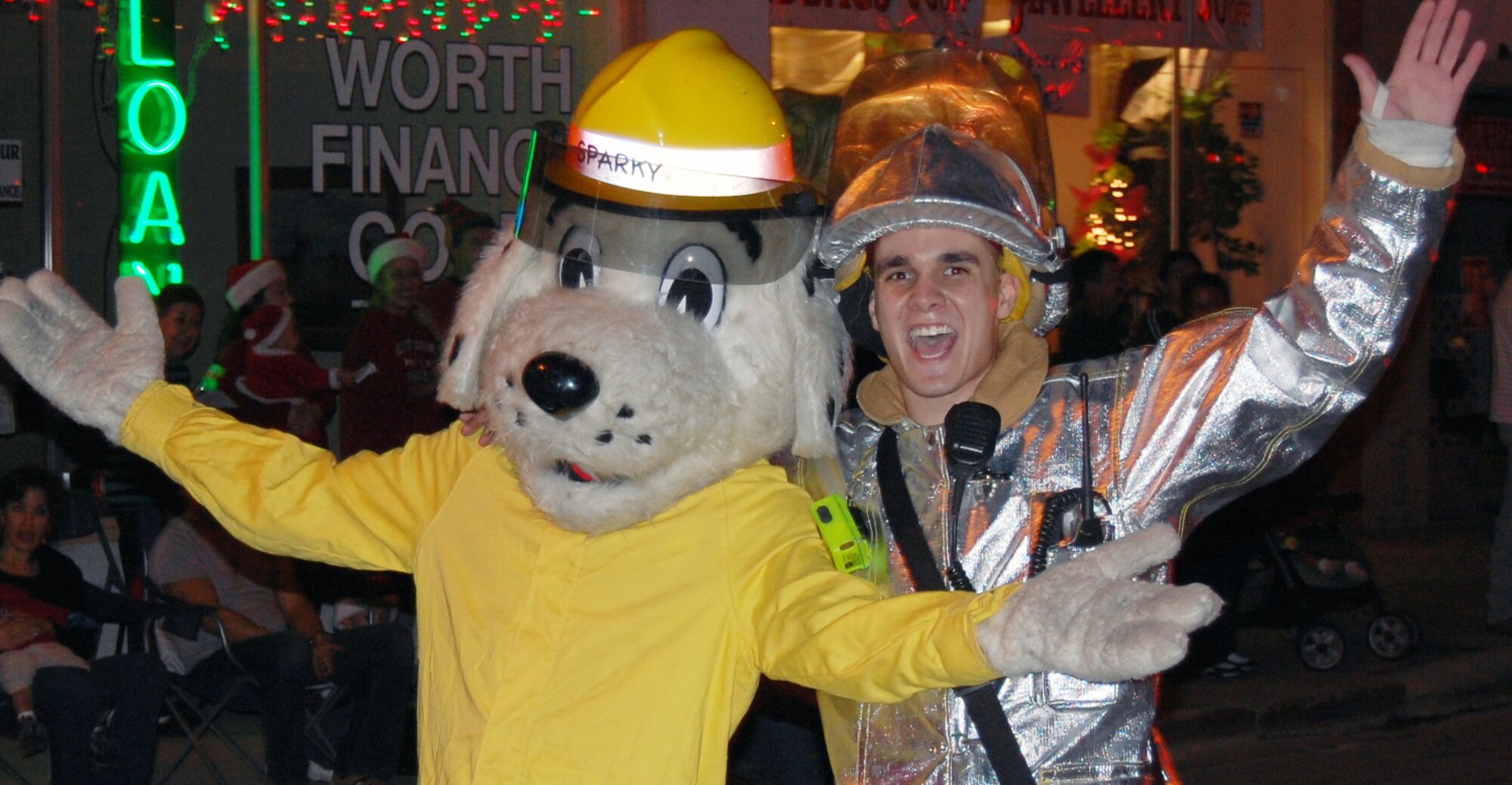 LAUGHLIN AIR FORCE BASE, Texas – Airman 1st Class Joseph Sleeman, Laughlin Fire Department, and Sparky wave to the crowd during the Del Rio Christmas parade Dec. 8. Many Laughlin members came out to support the community with a formation of Airman, a fire truck with Santa and much more. “It’s really hard to be away from family during the holidays, but being able to interact wit the Del Rio community, it makes Laughlin feel more like home,” said Airman 1st Class Lindy Leggett, 47th Aero Medical Dental Squadron. (U.S. Air Force photo by Tech. Sgt. Joel Langton)