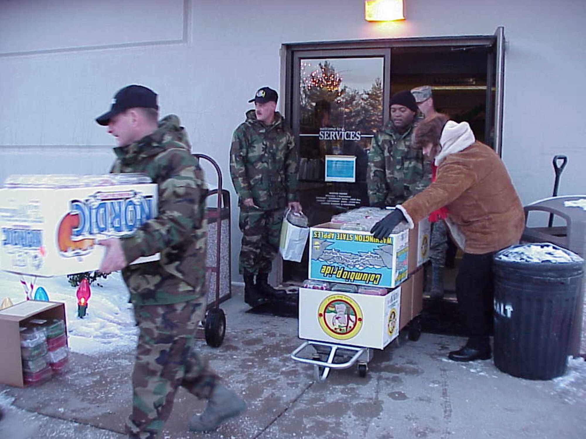 First Sergeants, led by Senior Master Sergeant Ray Munger, from the Air Force Research Laboratory, load trucks to begin the delivery of holiday cookies.  The Airman's Holiday Cookie Drive collected cookies to donate to young Airmen across the base Dec. 6.  (Courtesy photo)