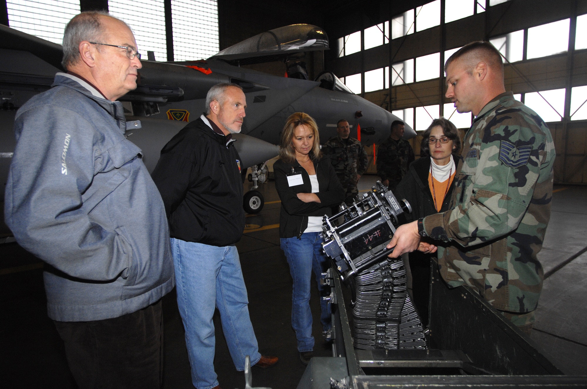 MOUNTAIN HOME AIR FORCE BASE, Idaho -- Tech. Sgt. James Smith, Maintenance Group Weapons, explains to honorary commanders Dave Jett, Alan Bermensolo, Charlene Wyman and Betty Van Gheluwe how an F-15 holds and fires munitions during their tour of the 366th Maintenance Group here Dec 7. The visit provided more than 20 of the wing’s honorary commanders an interactive, hands-on experience of maintenance operations and the opportunity to meet the Airmen who make it happen. (U.S. Air Force photo/ Airman 1st Class Ryan Crane)