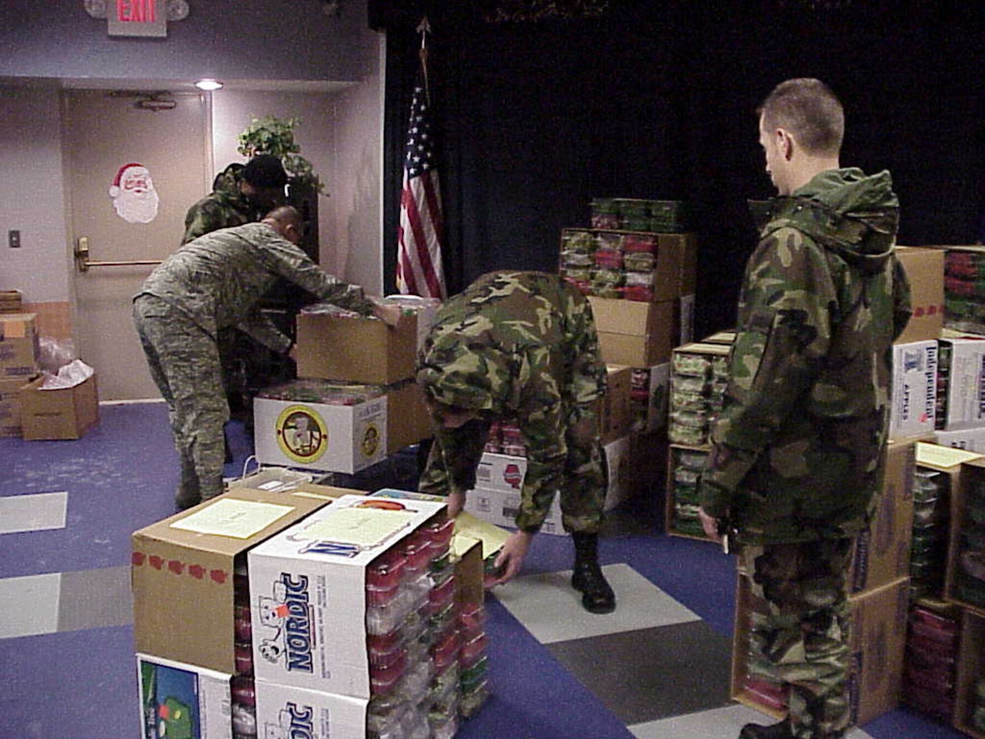 Master Sgt. Patrick Luda from the medical center watches as other First Sergeants prepare to load the cookies collected during the Airman's Holiday Cookie Drive Dec. 6 into the delivery trucks.  (Courtesy photo)