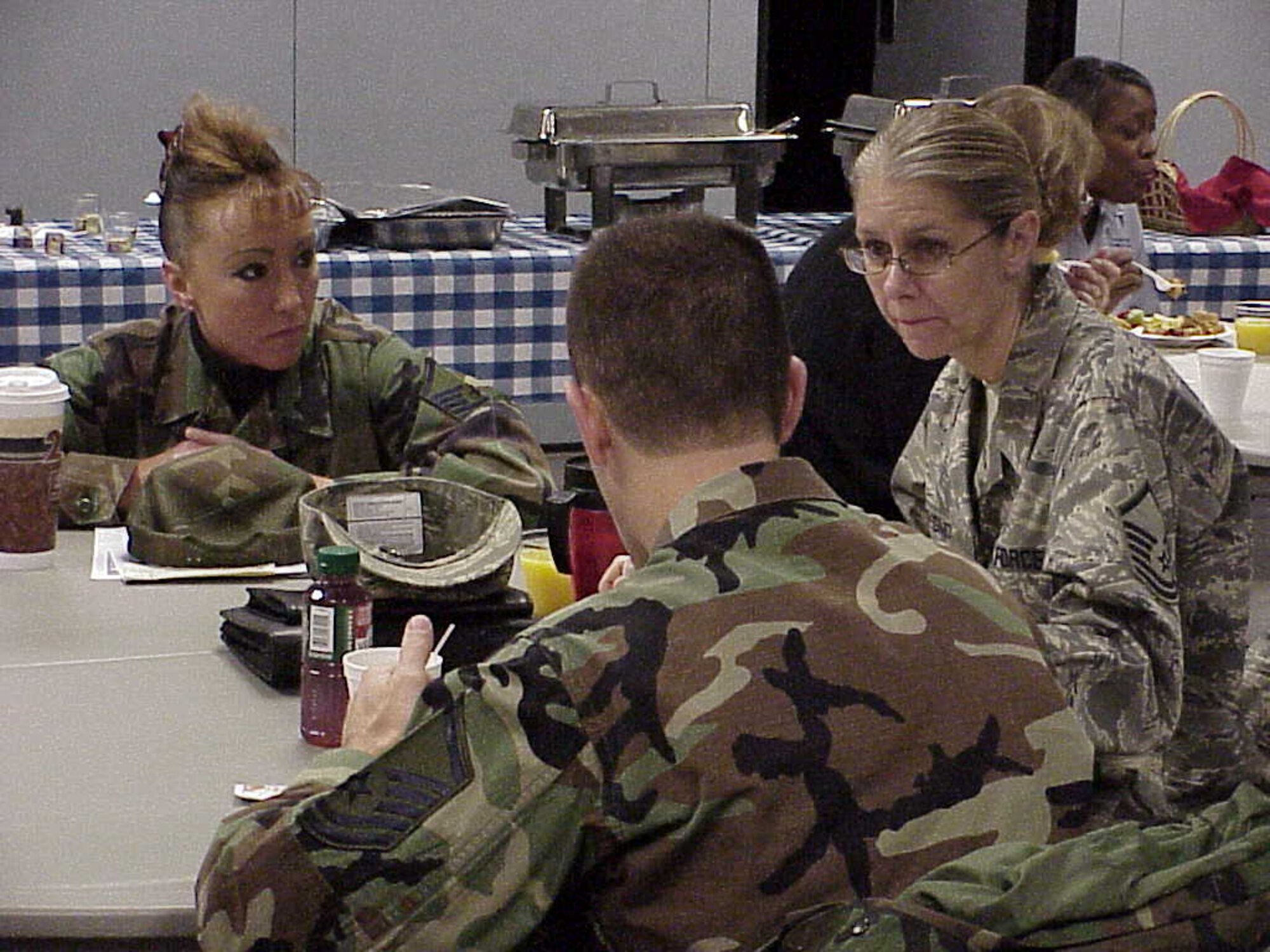 Master Sgt. Stephanie Michael, from the medical center, Master Sgt. Pamela Wilkins-Smith from the Mission Support Squadron, and Master Sgt. Patrick Luda from the medical center sit down to breakfast prior to the Airman's Holiday Cookie Drive Dec. 6.   Master Sgts. Michael, Wilkins-Smith and Luda are First Sergeants on base.  (Courtesy photo)