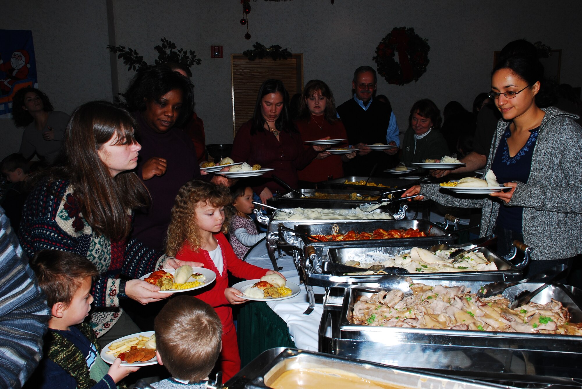 Families enjoyed the buffet-style Christmas dinner, offered by The Club, at the annual Hearts Apart Christmas Party here. Families of deployed Airmen came out to help celebrate the holidays with others in similar situations. (U.S. Air Force photo/Airman 1st Class Rebekah Phy)  