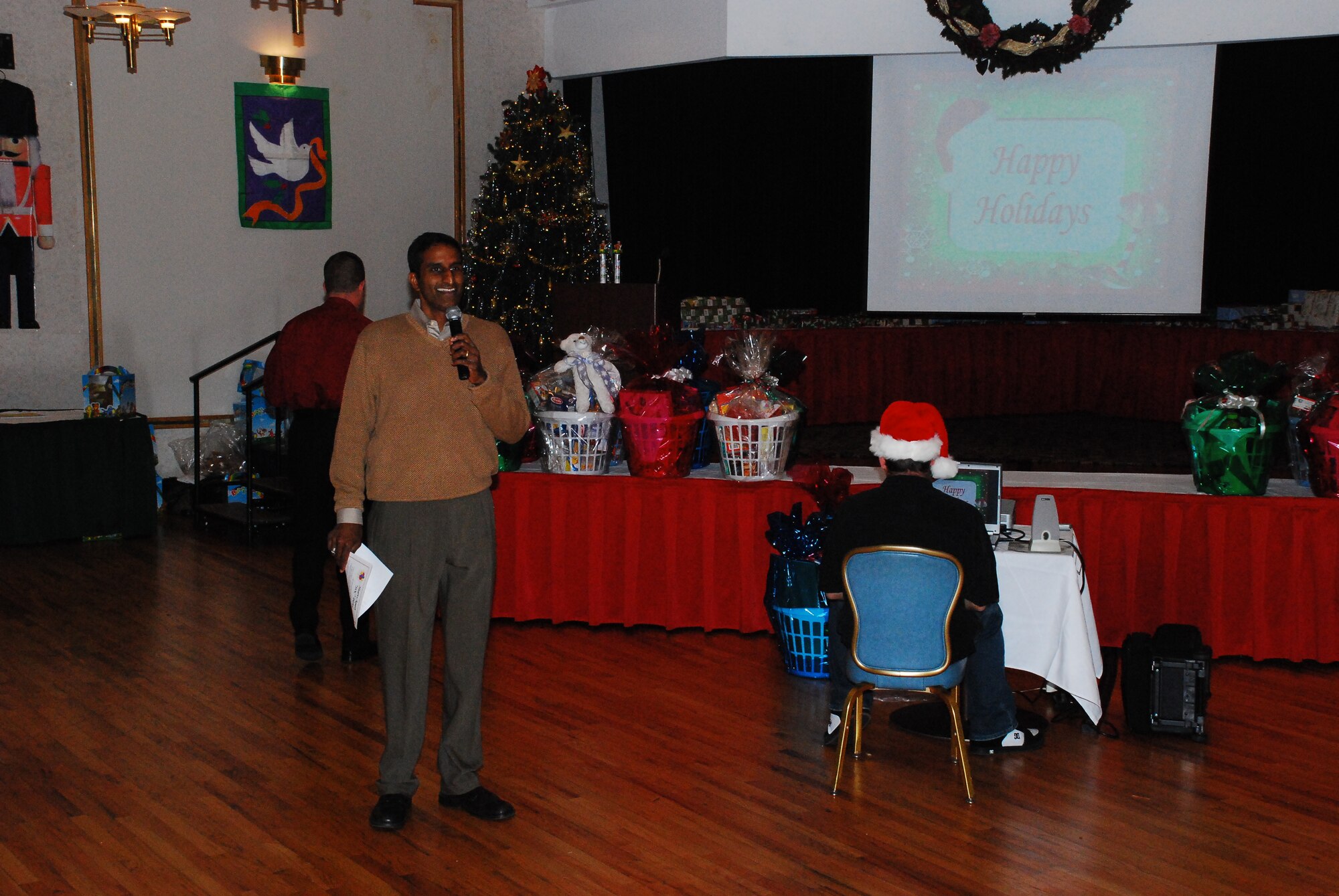 Col. Balan Ayyar, 305th Air Mobility Wing commander, gives the opening remarks at the annual Hearts Apart Christmas Party here recently. The commander thanked the families for their strength during difficult times, and reminded them all that they are loved and supported by Team McGuire. (U.S. Air Force photo/Airman 1st Class Rebekah Phy)  