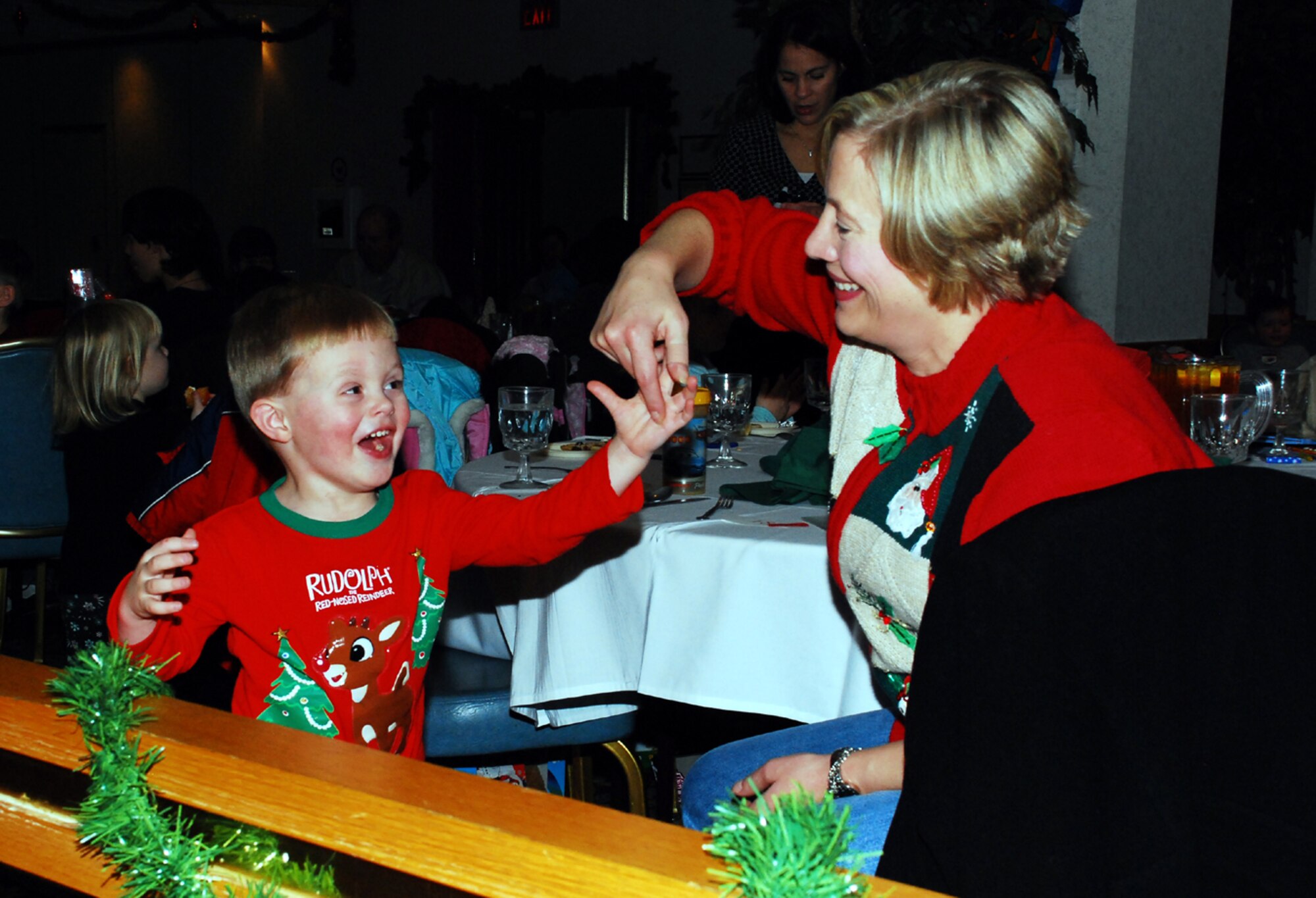 Susan Beidelman spins son, Anthony, 3, during the annual Hearts Apart Christmas Party here recently. The Hearts Apart program, run by the McGuire Airman and Family Readiness Center, offers families of deployed Airmen opportunities to get together and bond with others in similar situations. Several activities, including birthday and anniversary celebrations, are held each month, through Hearts Apart. (U.S. Air Force photo/Airman 1st Class Rebekah Phy)  
