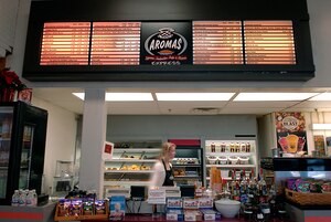 LANGLEY AIR FORCE BASE, Va. -- Diane Luckring, manager of Aromas Coffee Shop, sorts through items as she prepares for customers at the Langley food court Dec. 11. The shop, which opened Dec. 1, offers coffee, tea, fresh pastries, donuts, chicken and tuna sandwiches and soup. The hours of operation are Mondays through Fridays 6:30 a.m. to 8 p.m., Saturdays 7 a.m. to 7 p.m. and Sundays 9 a.m. to 6 p.m.  (U.S. Air Force photo/Airman 1st Class Vernon Young)