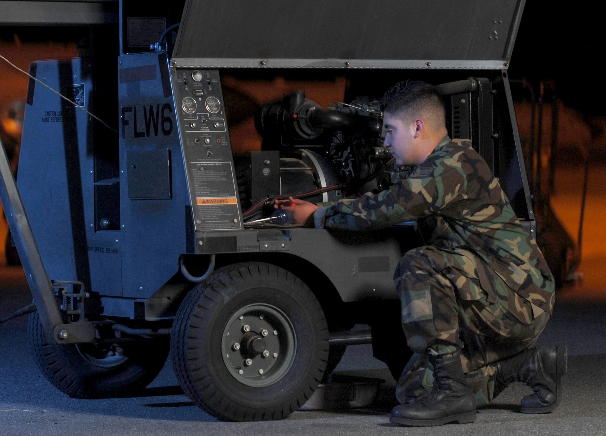 Staff Sgt. Jesus Fernandez inspects lighting equipment Dec. 5 at March Air Reserve Base, Calif. Sergeant Wilson, an aircraft generation equipment technican from the 452nd Maintenance Squadron, is an air Reserve technician here. Air Reserve technicians are full-time civilian employees of the Air Force who must maintain active status as reservists in the Air Force Reserve unit in which they are employed. They are permanent employees who, in the event of mobilization, are available for active duty in their assigned military position. They are essential for the operational readiness of their Reserve unit. (U.S. Air Force photo/Val Gempis) 
