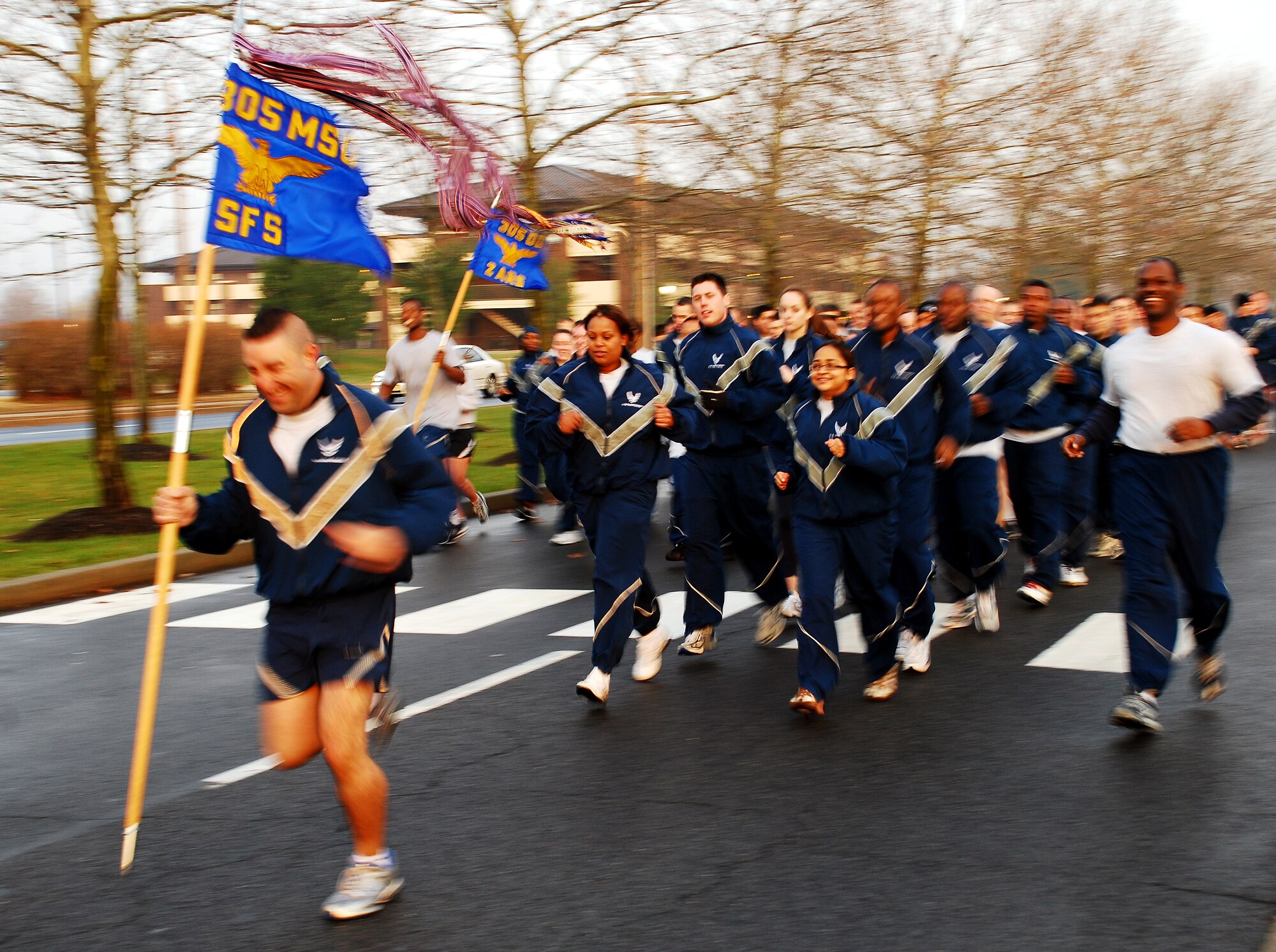 Airmen from the 305th Security Forces Squadron take off during the “Wingman Day” run Dec. 12 here. Squadrons lined up to participate in the run to help celebrate Wingman Day, showcase unity and signify watching out for your wingman. Airmen are encouraged to participate in activities offered around base Dec. 12, including a luncheon held at Hangar 3211. For more information, call (609) 754-2988. (U.S. Air Force photo/Airman 1st Class Rebekah Phy)   