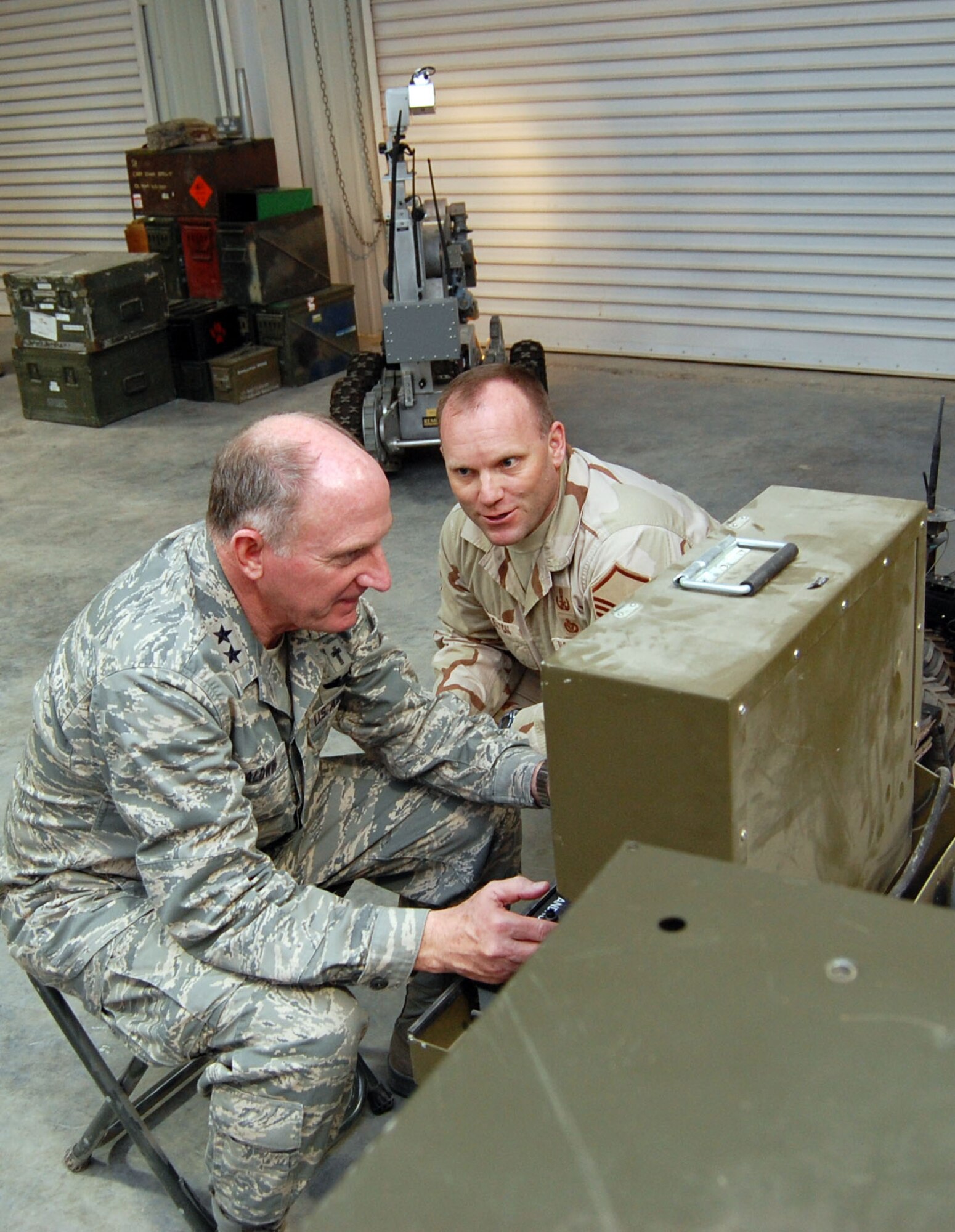 SOUTHWEST ASIA – Master Sgt. Christopher Skelton shows Maj. Gen. Charles Baldwin how to operate the F6A robot at an air base in the Middle East Nov. 6. Sergeant Skelton is assigned to the 386th Civil Engineer Squadron explosive ordinance disposal unit as a flight chief; he is from the 144th Fighter Wing, Fresno Air National Guard Base, Calif. Chaplain Baldwin is the Air Force’s chief of chaplains. (Air Force photo\ Staff Sgt. Phillip Butterfield)
 
