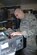 BALAD AIR BASE, Iraq -- Senior Airman Justin White, a 332nd Expeditionary Communications Squadron small computers technician, reattaches the face plate of a repaired desktop computer here. Airman White is deployed from Langley Air Force Base, Va. (U.S. Air Force photo/Senior Airman Terri Barriere)
