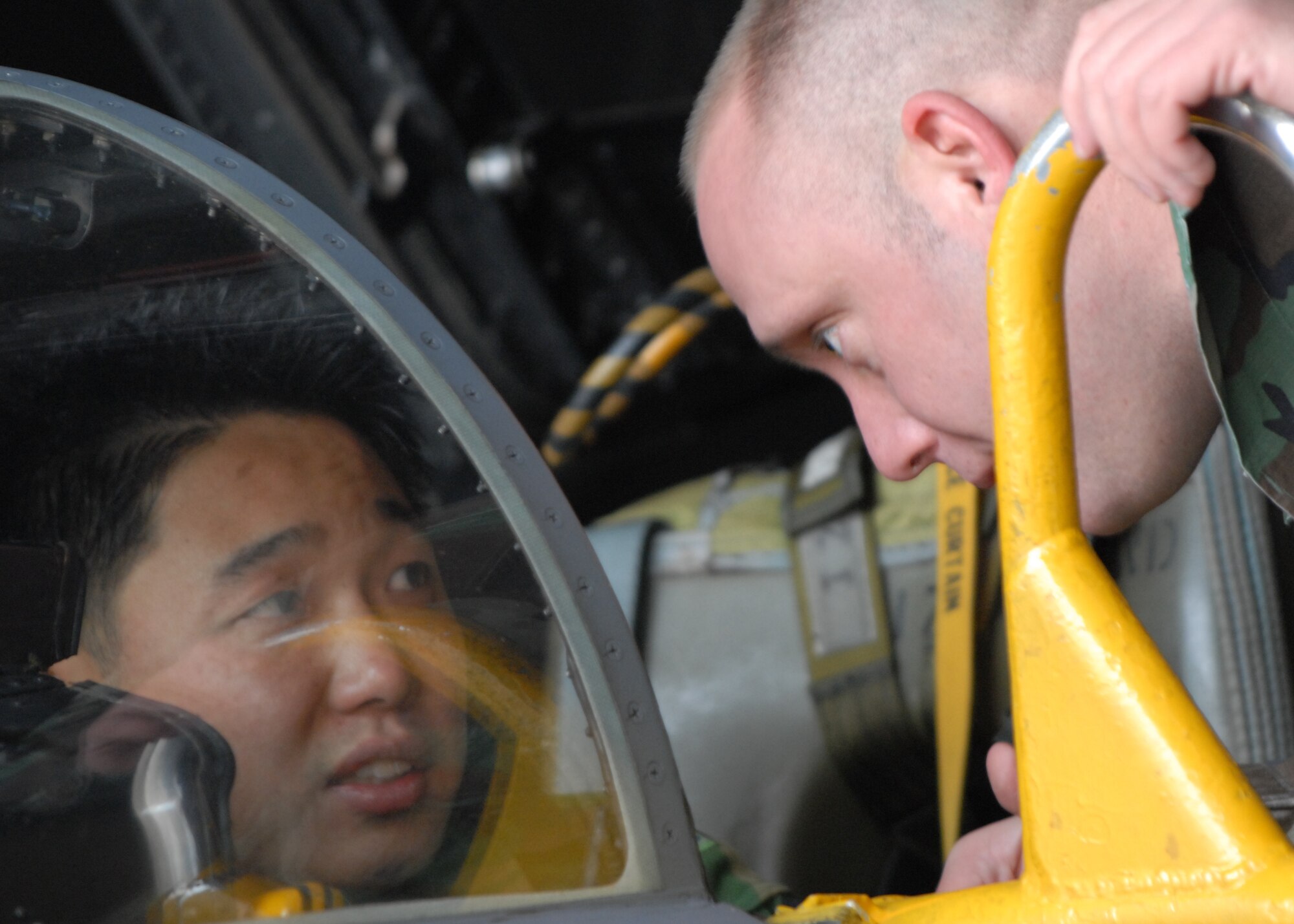 CHUNG JU AIR BASE, South Korea—Republic of Korea Air Force Tech. Sgt. Su Min, 17th Fighter Wing (left) explains different components of the F-4 cockpit to Tech. Sgt. Jason Smith, 8th Maintenance Group Dec. 7 here. The training is a way for U.S and Republic of Korea Airmen to develop teamwork learn from each other to improve war fighting capabilities. (U.S. Air Force Photo/Staff Sgt Araceli Alarcon) 

