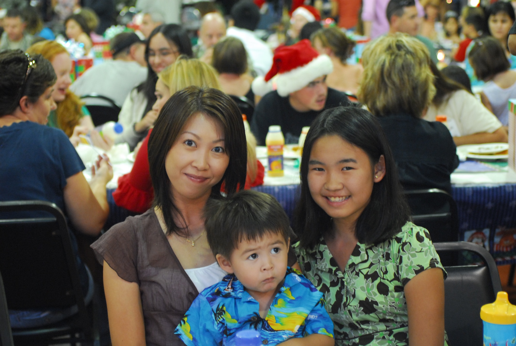 Allen and Mari, son and daughter of James Fernett ,15th Civil Engineer Squadron deployed to Southwest Asia, pose for a picture during the holiday party put on by the Airman and Family Readiness Center. (U.S. Air Force Photo/Staff Sgt. Erin Smith)
