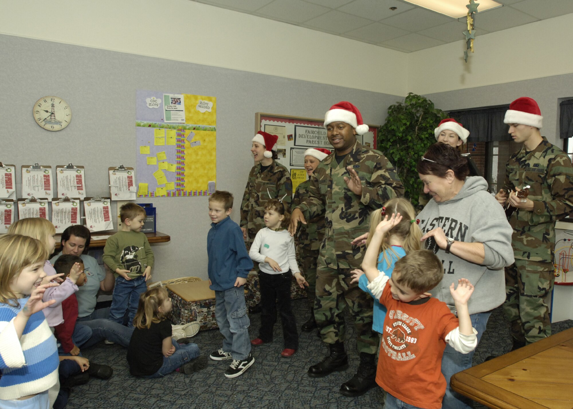 FAIRCHILD AIR FORCE BASE, Wash – Staff Sgt. Ronicle Ellison, a member of the base performance band, Travis Air Force Base, Calif., joined by fellow vocalists, perform Christmas carols for the children at the Child Development Center Dec.11. The group of vocalists spent the day touring the base and singing Christmas carols to the Airmen. (U.S. Air Force photo / Senior Airman Eunique Stevens) 
