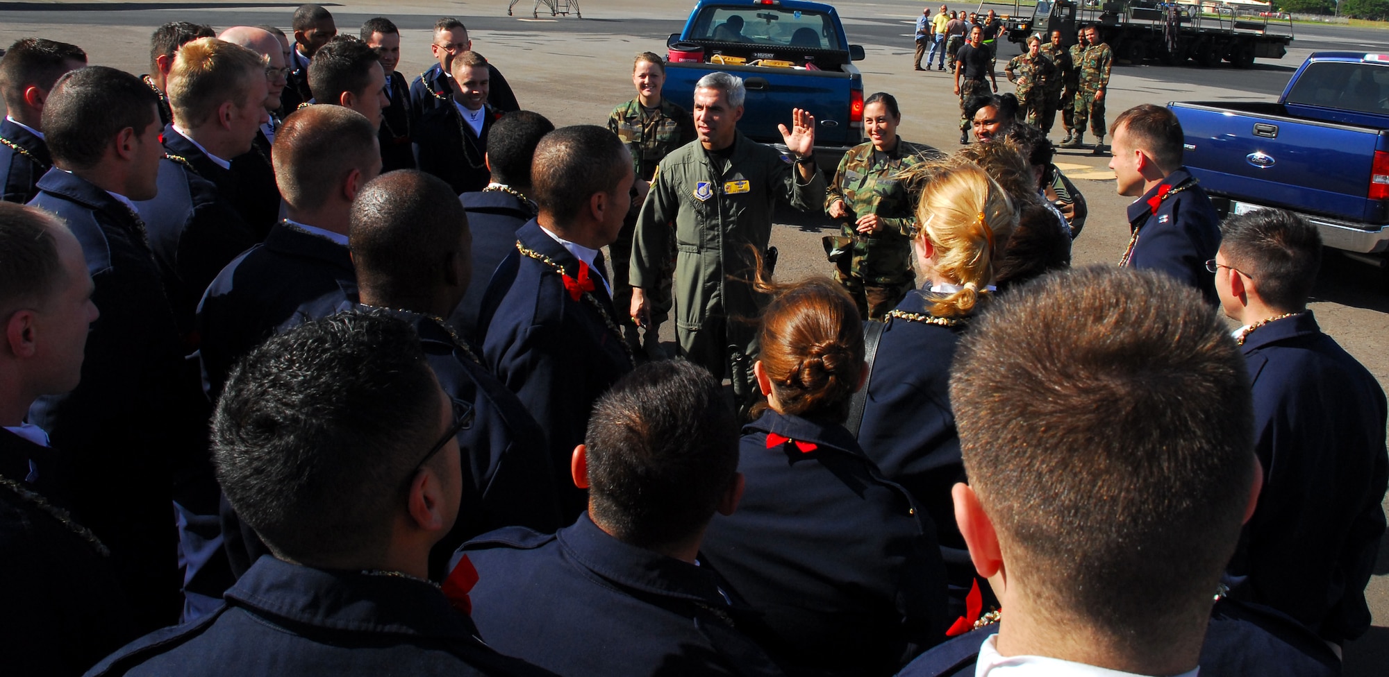 Col. JJ Torres, 15th Airlift Wing commander, welcomes Tops In Blue members to Hickam AFB. Col. Torres met TIB members on the Hickam tarmac upon their arrival. Photo by Staff Sgt. Erin Smith