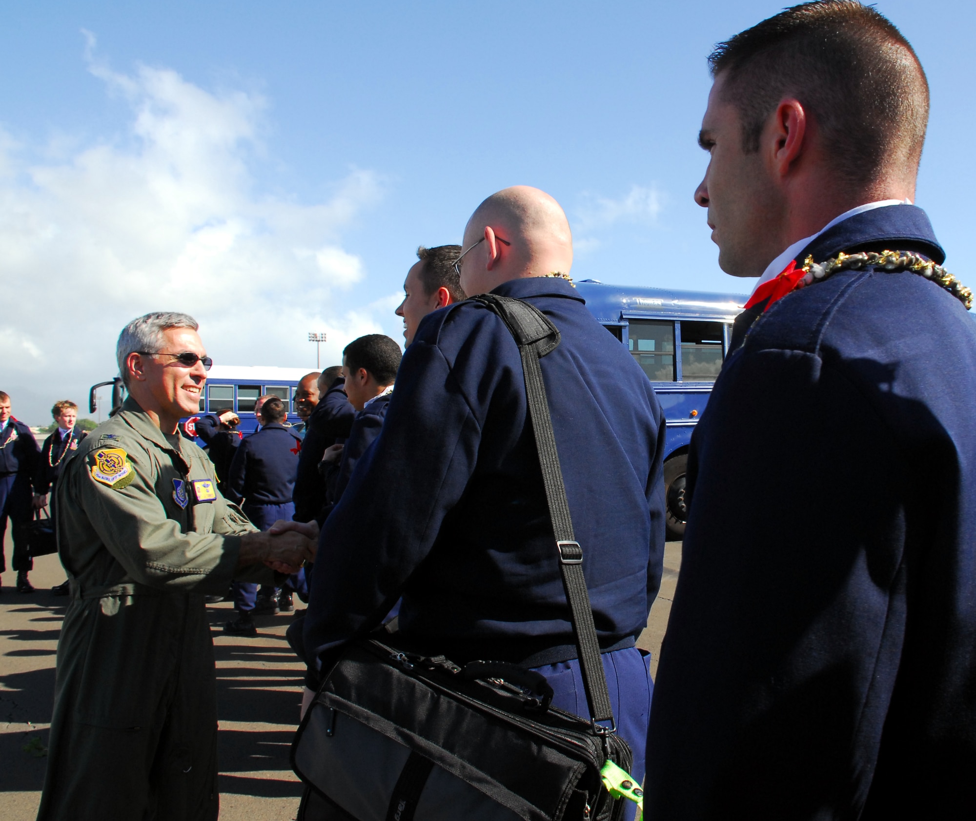 Col. JJ Torres, 15th Airlift Wing commander, greets Tops In Blue members upon their arrival at Hickam AFB, Dec. 12. Tops in Blue members will be performing Dec. 15 at 7 p.m. at the Freedom Tower Mall.  Photo by Staff Sgt. Erin Smith