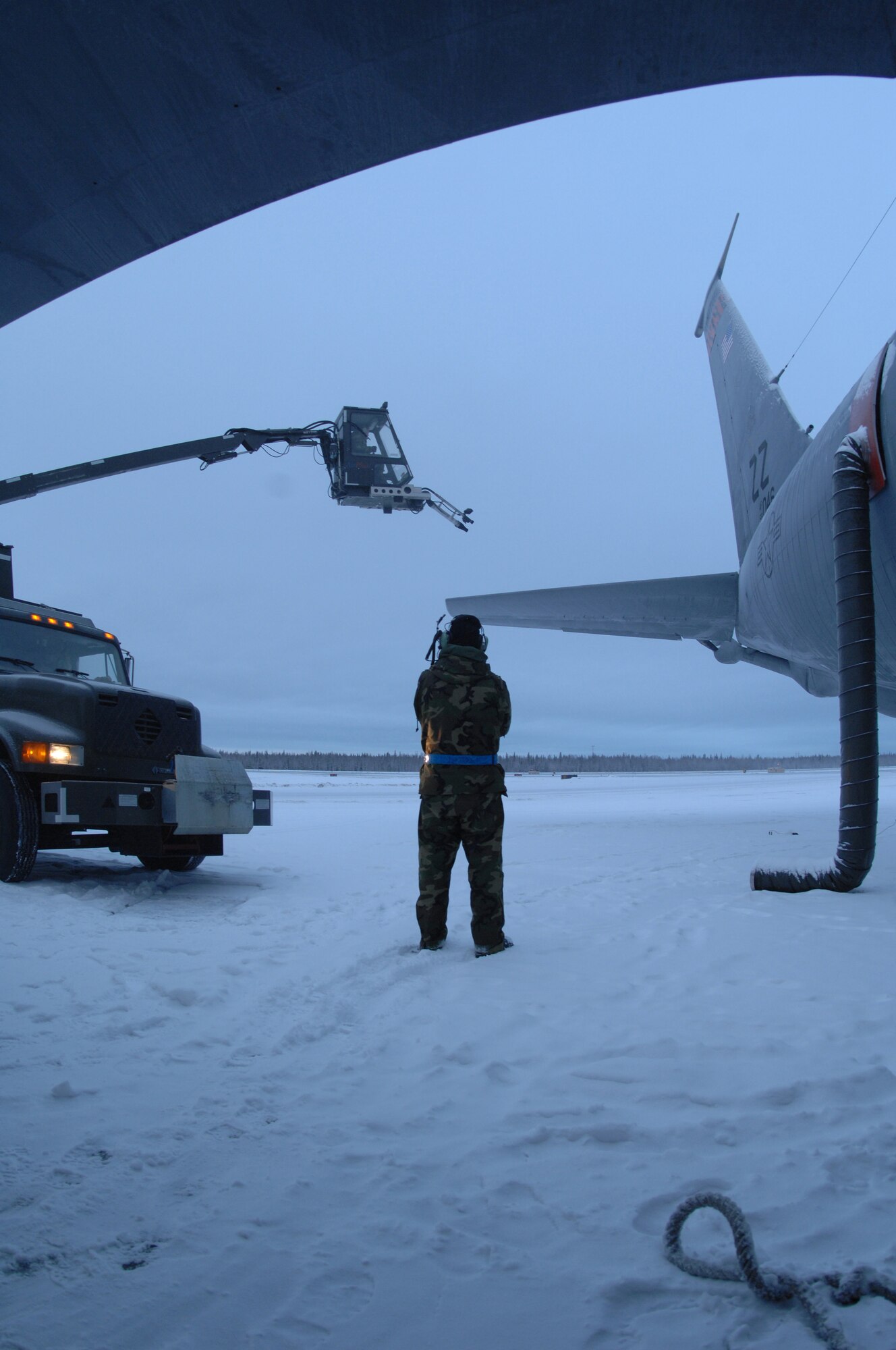 EIELSON AIR FORCE BASE, Alaska -- Senior Airmn Seth Harbor, 354th Aircraft Maintenance Squadron, instructs the operator of the de-icer on where to blow snow off of a KC-135 Dec. 12, 2007 on the Eielson flightline. Due to the arctic conditions and the continuous snow fall during Alaska's extended winters, Eielson maintainers are on constant standby to assure all aircraft are ready for take-off at moment's notice.  (U.S. Air Force photo by Airman 1st Class Christopher Griffin)