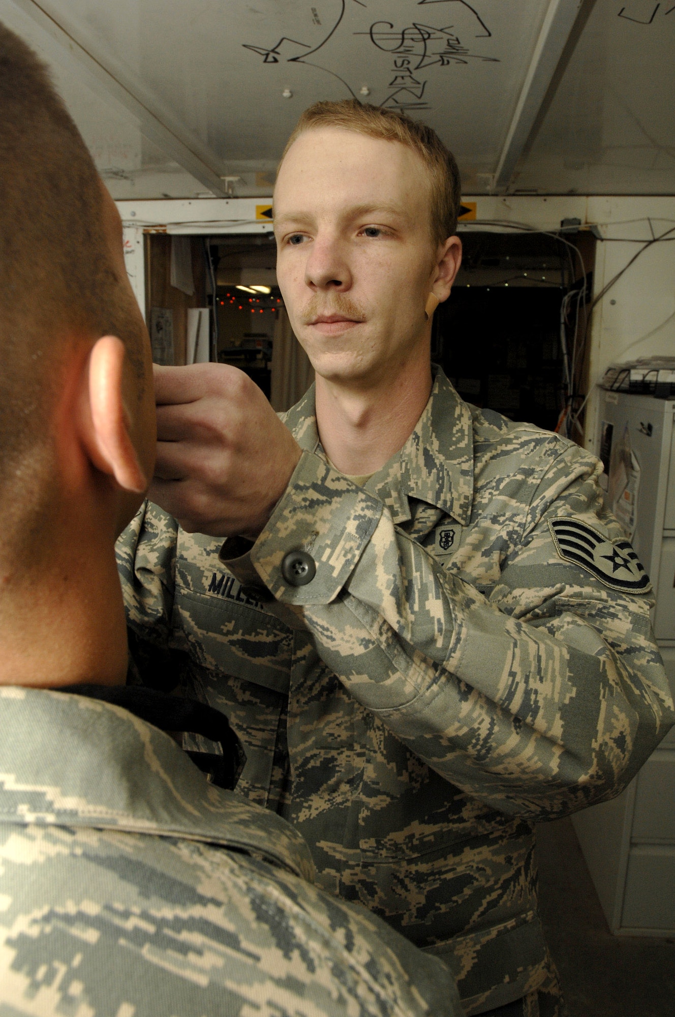 Staff Sgt. Brian Miller administers flu mist to a patient Dec. 11 in the407th Expeditionary Medical Squadron Clinic at Ali Base, Iraq. Sergeant Miller is a medical technician and assists with vaccinations, minor procedures and documentation of medical care. Sergeant Miller is deployed from Seymour Johnson Air Force Base, N.C. (U.S. Air Force photo/Airman 1st Class Jonathan Snyder) 
