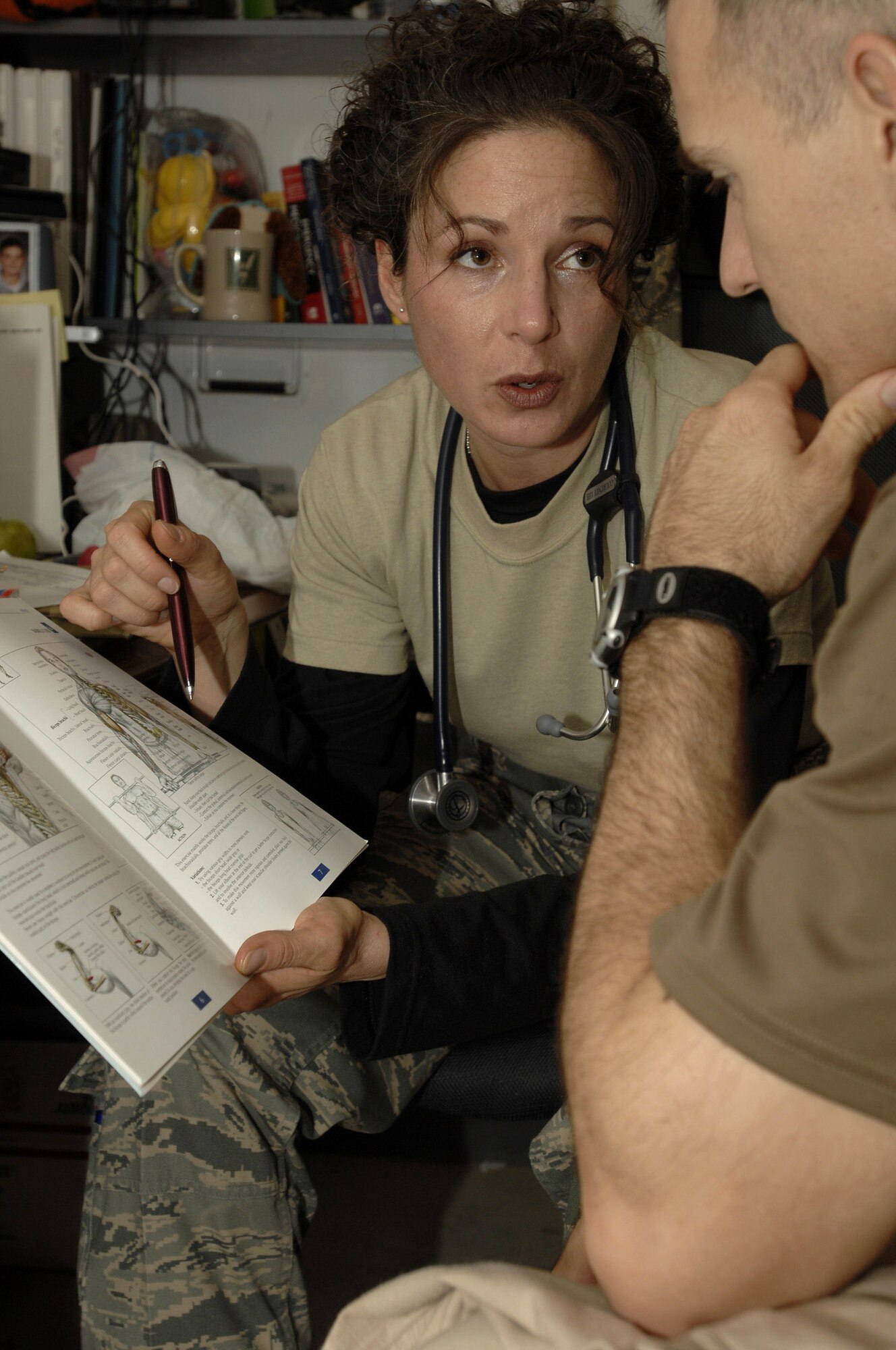 Physician Assistant Capt. Courtney Lee shows a patient his exact injury and explains how to rehabilitate from it Dec. 11in the 407th Expeditionary Medical Squadron Clinic at Ali Base, Iraq. Captain Lee is responsible for the care of Air Force personnel on base and is one of ten medical members who are emergency medicine certified. Captain Lee is deployed from Travis Air Force Base, Calif. (U.S. Air Force photo/Airman 1st Class Jonathan Snyder) 