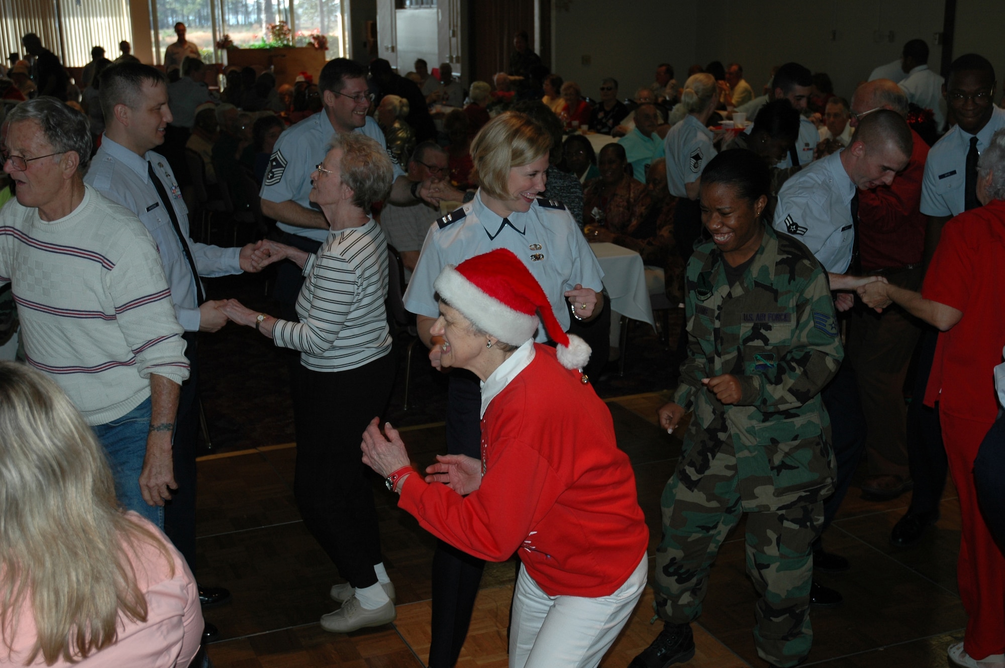 Volunteers from Tyndall Air Force Base and guests from the Bay County Council on Aging and Sims Veterans Nursing Home dance during Tyndall's 21st annual Golden Age Christmas Party Dec. 13 at the CAC Annex.  More than 200 senior citizens and veterans were invited to the party. (Air Force photo by Airman 1st Class Anthony J. Hyatt)