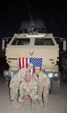 Staff Sgt. Andrew Finan, Airmen 1st Class Cody Newsom and Brittany Musleh, 732nd Expeditionary Logistics Readiness Squadron deployed from Whiteman Air Force Base pose in front of a gun truck at Logistics Support Area Anaconda Nov. 13, 2005. (Photo printed with permission of Staff Sgt. Andrew Finan)
