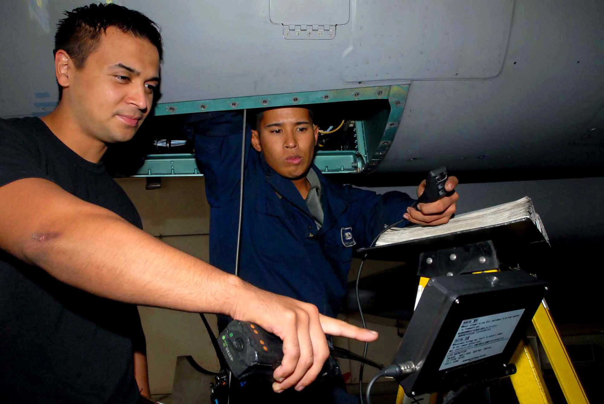 Senior Airman Ruben Labrador (left) and Staff Sgt. Martin Ramirez use a fiber optic video scope to look inside inaccessible places in the F-15 Eagle at Kadena Air Base, Japan. Airman Labrador is assigned to the 18th Aircraft Maintenance Squadron, and Sergeant Ramirez works with the 18th Equipment Maintenance Squadron. Maintenance members at Kadena AB continue inspections as part of a fleet-wide F-15 stand-down. (U.S. Air Force photo/Senior Airman Darnell Cannady) 
