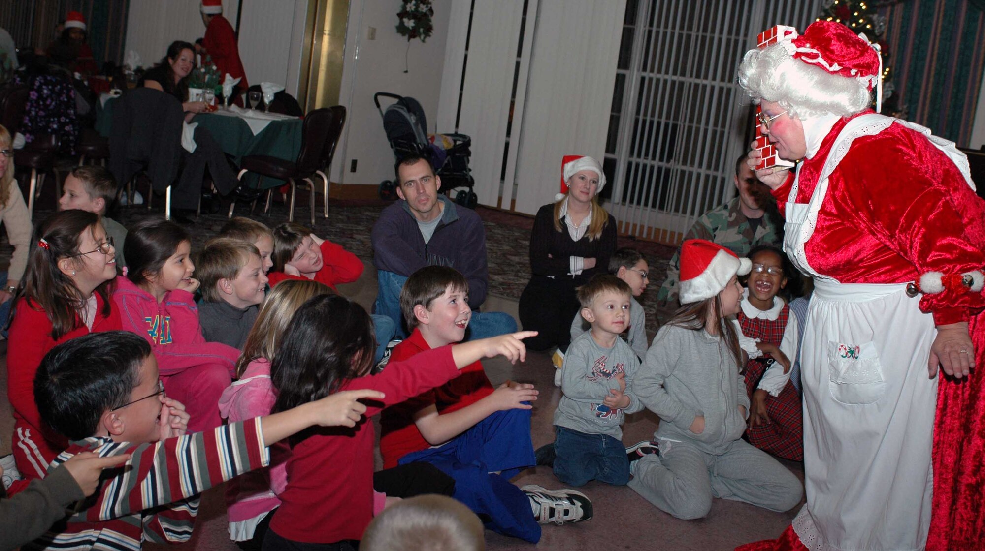 Mrs. Claus entertains children with a magic show during the Holiday Blast Special Needs Dinner at the Travis Conference Center Dec. 12. The event featured games, prizes and caroling. (U.S. Air Force photo/Staff Sgt. Matthew McGovern) 