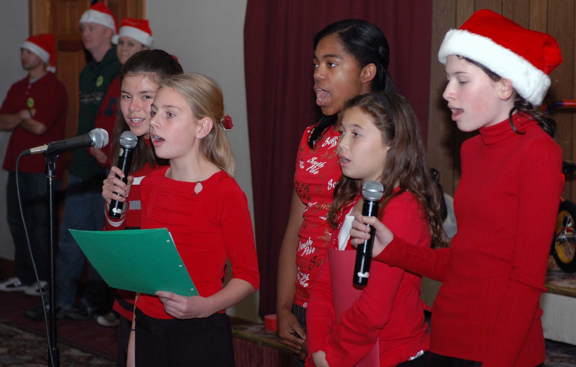 Children spread the holiday cheer while singing Christmas carols during the Holiday Blast Special Needs Dinner at the Travis Conference Center Dec. 12. The event featured games, prizes and caroling. (U.S. Air Force photo/Staff Sgt. Matthew McGovern)