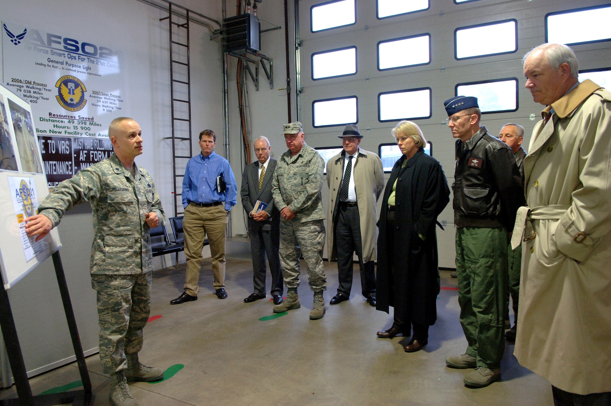 Lt. Col. Paul Pellegrino (left) briefs Secretary of the Air Force Michael W. Wynne (far right) and other senior executives and general officers on Air Force Smart Operations for the 21st century projects implemented throughout his squadron Dec. 11 at Ramstein Air Base, Germany. Colonel Pellegrino is the 435th Vehicle Readiness Squadron commander. (U.S. Air Force photo/Airman 1st Class Kelly LeGuillon) 
