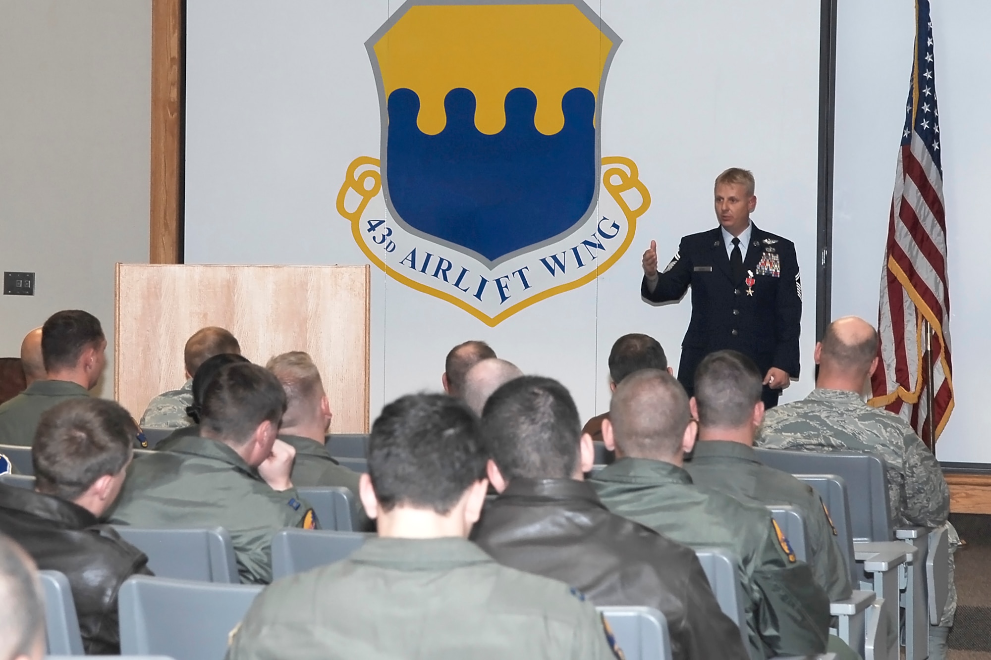 Senior Master Sgt. Sean Wong speaks to members of Pope Air Force base leadership and the 2nd Airlift Squadron after receiving the Bronze Star during the “Heroes Past and Present” event Dec. 7. Sergeant Wong received the award for exceptional meritorious achievement to the United States as a Combat Aviation Advisor and C-130 Standardization and Evaluation Loadmaster during Operation IRAQI FREEDOM. (U.S. Air Force photo by Lorna Sanchez)