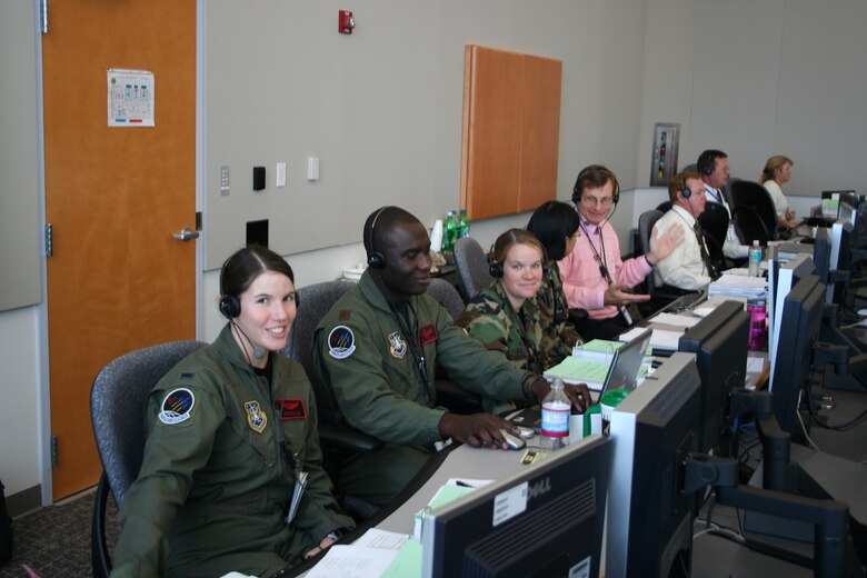 (l to r) 1st Lt. Georgene Hilb, Maj. Eric Amissah, Capt. Davina Fallaw, Capt. Bai Zhu and Stephen Anstey work on console at the Technical Support Facility during Atlas V pre-launch operations Dec. 10. (Courtesy photo)