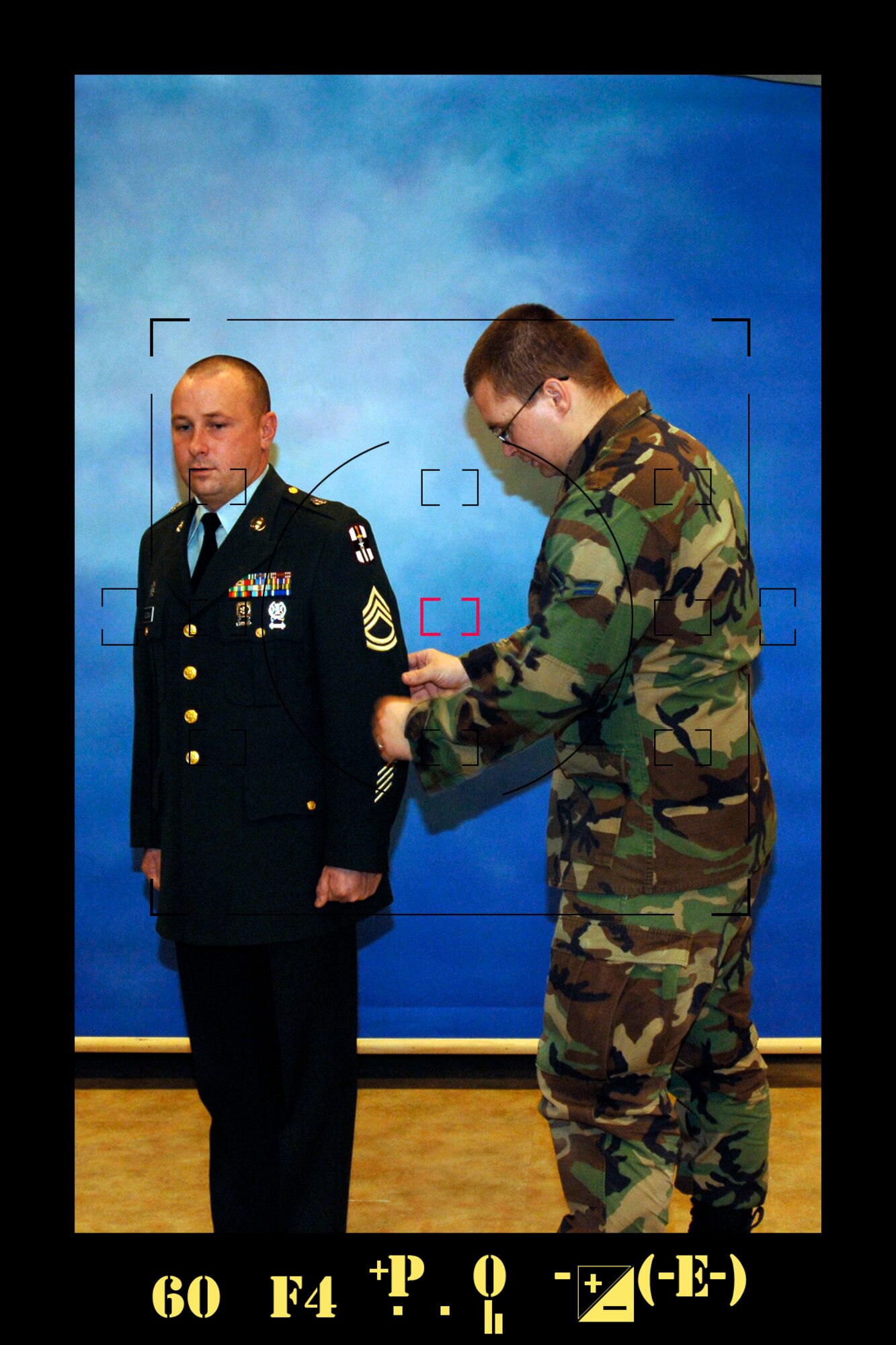 MCCONNELL AIR FORCE BASE, Kan. -- Airman 1st Class Roy Lynch, 22nd Air Refueling Wing Public Affairs, adjusts Army Sgt. 1st Class Jason Goodman’s, 89th Regional Readiness Command, uniform before taken his photography in the studio.  McConnell’s Public Affairs photographers support Army and Navy personnel as well as Air Force members with studio photography for official portraits for Air Force General Officers, awards packages, special duty assignments, official passports, and citizenship applications for every branch.  (Photo illustration by Airman 1st Class Maria Ruiz)