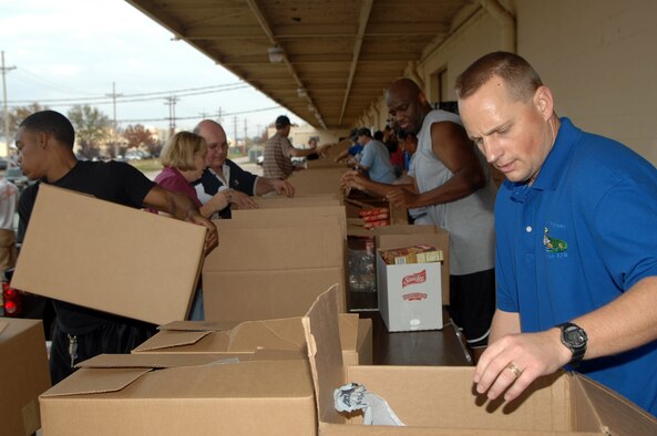 Master Sgt. Don Jessee, 8th Air Force first sergeant, works a food box assembly line with other first sergeants and volunteers outside the 2nd Logistics Readiness Squadron warehouse at Barksdale Air Force Base, La., Dec. 11.   Angel Food Ministries visited Barksdale, for the first time, to deliver more than 220 boxes of food to Airmen and their families.(U.S. Air Force photo by Airman 1st Class Joanna M. Kresge)(Released)