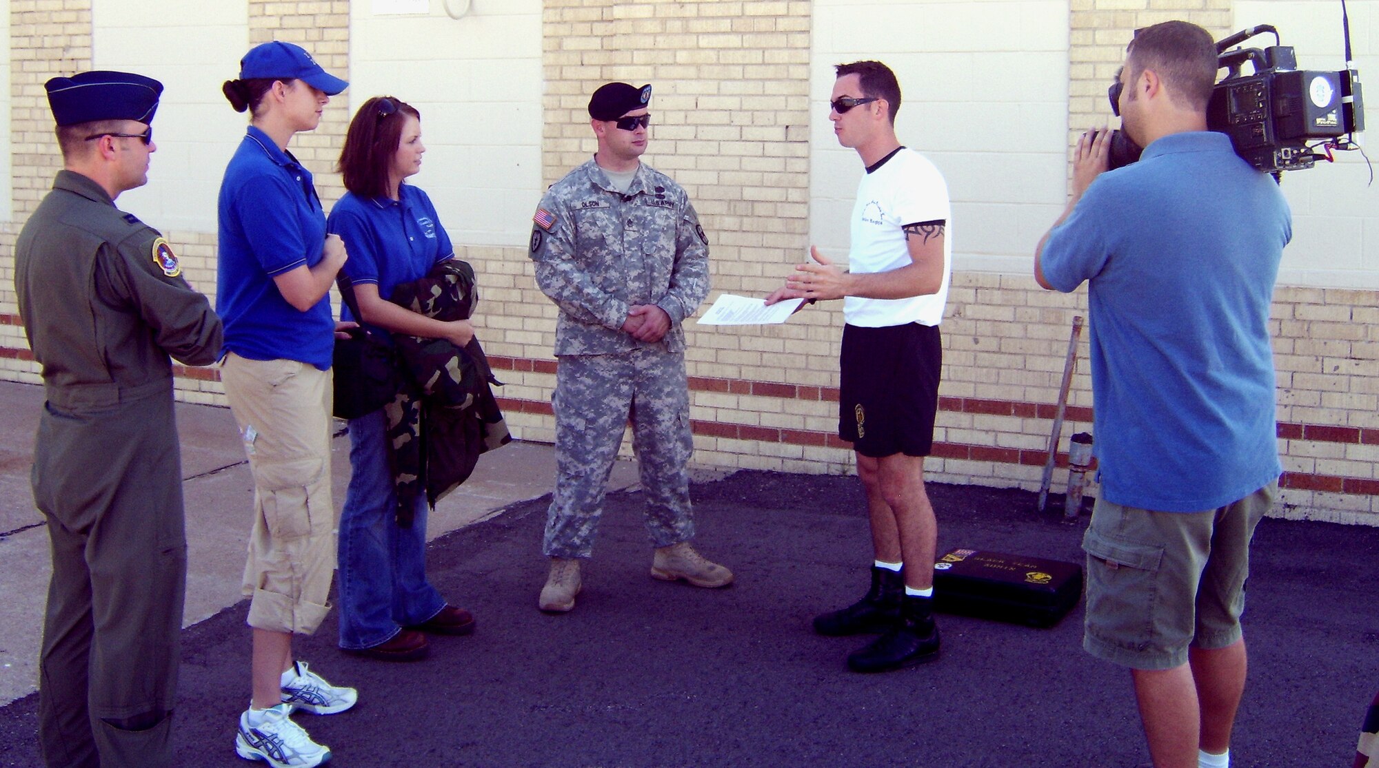 MCCONNELL AIR FORCE BASE, Kan. – A member of a local media organization interviews military members before being allowed to accompany a Golden Knights demonstration flight at the 2007 McConnell Open House. Some of Public Affairs responsibilities include escorting, facilitating and containing local media. (photo by Army Capt. Marcos Cervantes)