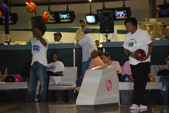 Chief Master Sgt. Laverne Vick (right), from LRS, sizes up the pins before scoring a Strike.  Mentors, like Chief Vick, are needed and serve as role models for TYC youths who are rejoining thier local community