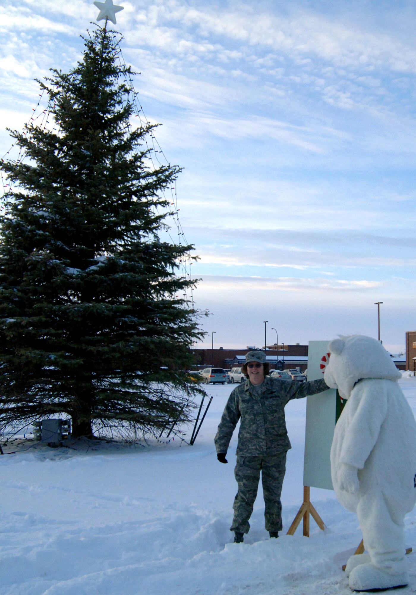 GRAND FORKS AIR FORCE BASE, N.D. -- Col. Diane Hull, 319th Air Refueling Commander, and Dakota the polar bear prepare to pull the switch to the holiday tree Dec. 6 here. (U.S. Air Force photo/Senior Airman SerMae Lampkin)