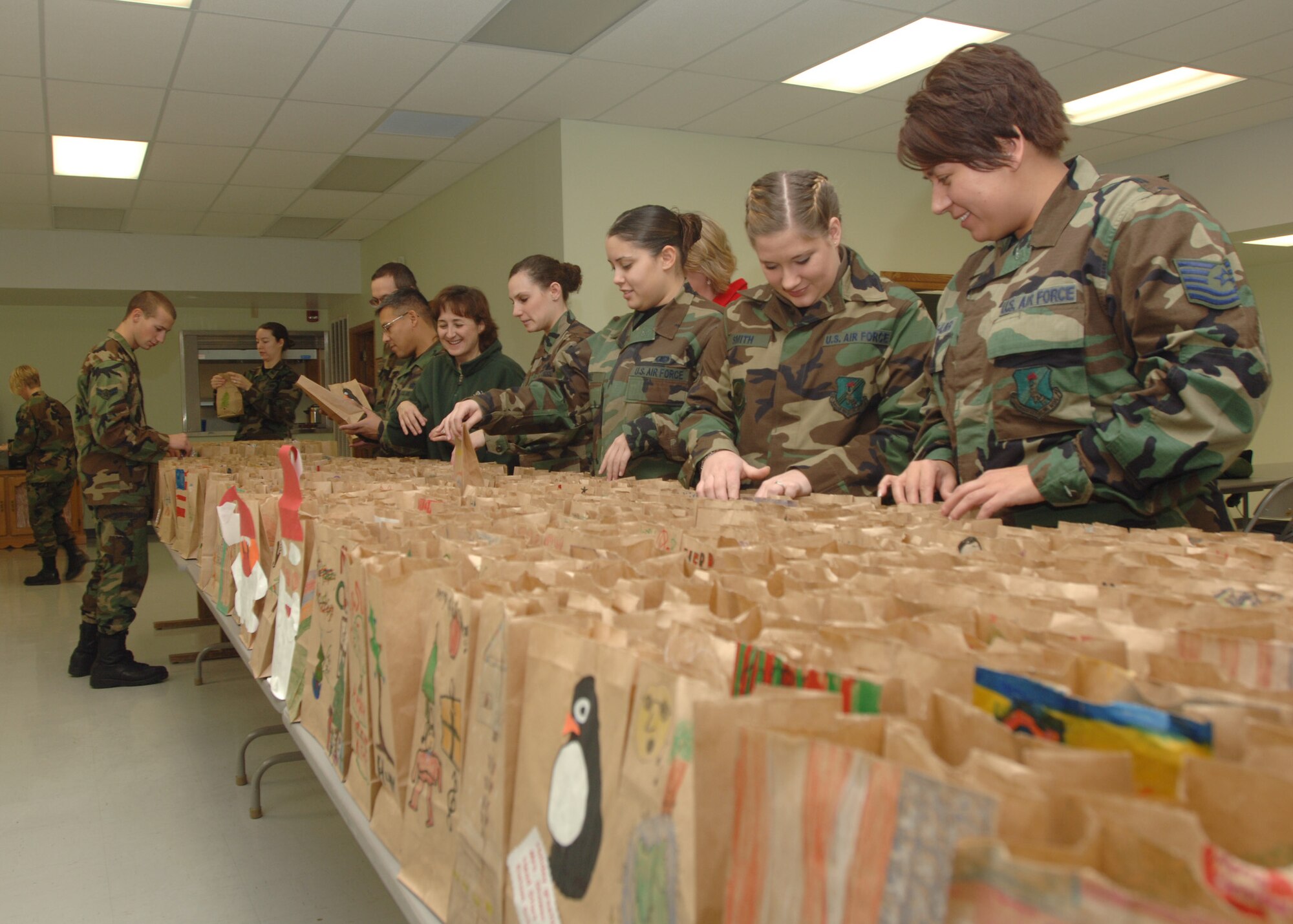 GRAND FORKS AIR FORCE BASE, N.D. -- Nearly 500 Warriors of the North volunteers put together paper of bags of assorted baked goods during an annual cookie drive here Dec. 12.  The cookie drive was orchestrated to provide young Airmen living in the dorms with a taste of home while away from family during the holiday season. 
(photo/ Senior Airman Chad M. Kellum)
