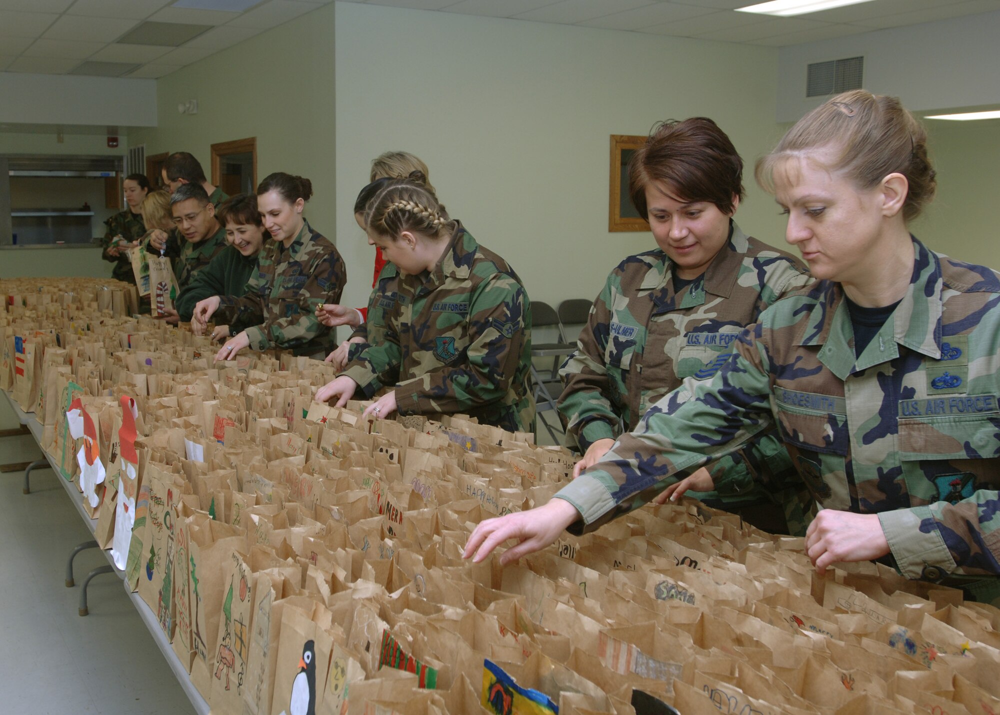 GRAND FORKS AIR FORCE BASE, N.D. -- Nearly 500 Warriors of the North volunteers put together paper of bags of assorted baked goods during an annual cookie drive here Dec. 12.  The cookie drive was orchestrated to provide young Airmen living in the dorms with a taste of home while away from family during the holiday season. 
(photo/ Senior Airman Chad M. Kellum)
