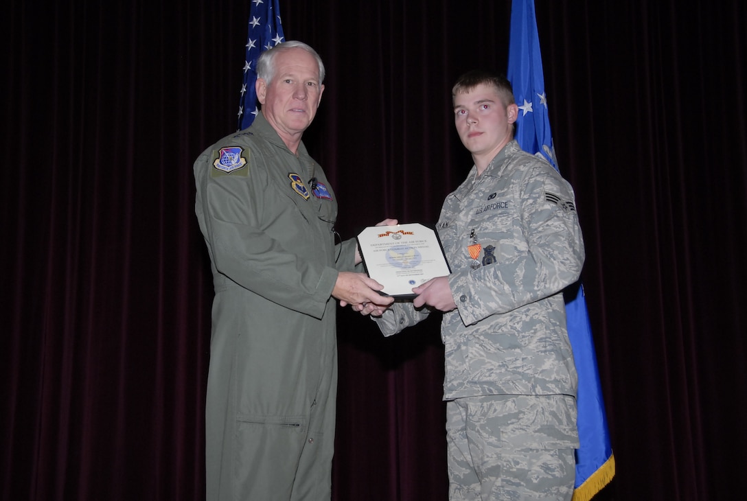 Gen. William R. Looney III, Air Education and Training Commander, presents the Combat Action Medal to Senior Airman Shawn Ryan, 82nd Security Forces Squadron, at the base theater Nov. 29. (U.S. Air Force photo/Mike Litteken)