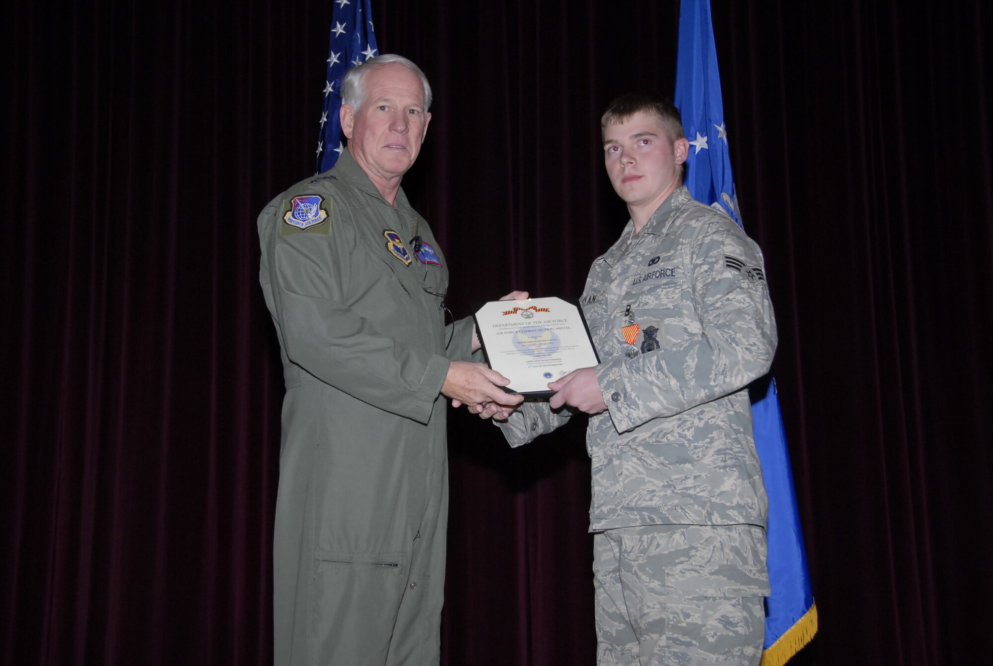 Gen. William R. Looney III, Air Education and Training Commander, presents the Combat Action Medal to Senior Airman Shawn Ryan, 82nd Security Forces Squadron, at the base theater Nov. 29. (U.S. Air Force photo/Mike Litteken)