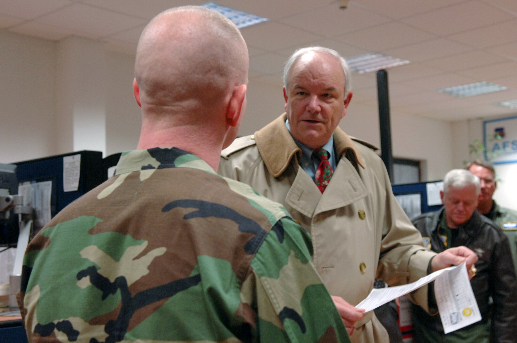 During a briefing to Senior AF leaders including Gen Art Lichte, AMC Commander (right) and Lt Gen John Bradley, Commander, AF Reserves (far right), Secretary of the Air Force, Michael W. Wynne (middle), praised the dramatic improvement made in the vehicle registration process by the 569th US Force Protection Squadron and encouraged the unit to continue improving customer service as an important quality of life issue.  The effort, led by Maj. Jeffrey Carter (left) as part of an Air Force Smart Operations for the 21st Century initiative, cut the time required to register a vehicle from about 2 hours to less than 30 minutes. (U.S. Air Force Photo by Airman 1st Class Kelly LeGuillon)