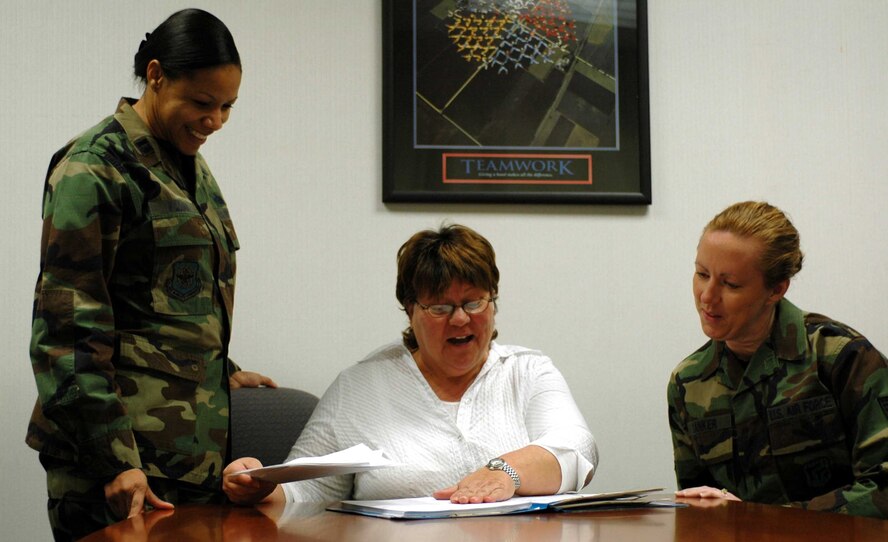 Capt. Patrice Williams, Shirley Philipp and Tech. Sgt. Melanie Danker, all of the 60th Air Mobility Wing, look over files recently in the Military Equal Opportunity/Equal Employment Opportunity office. The two will merge into one office beginning Jan. 1, 2008. (U.S. Air Force photo/Nick DeCicco)