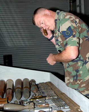 MCCONNELL AIR FORCE BASE, Kan. -- Tech. Sgt. Phillip Hauser, 22nd Civil Engineer Squadron, checks over explosive ordinance at the Kansas Museum of Military History on Nov. 19. One of the many tasks of Explosive Ordinance Disposal members are to train in emergency situations where transporting explosives and equipment from locations to authorized disposal areas.  (Photo by Airman 1st Class Roy Lynch III)          