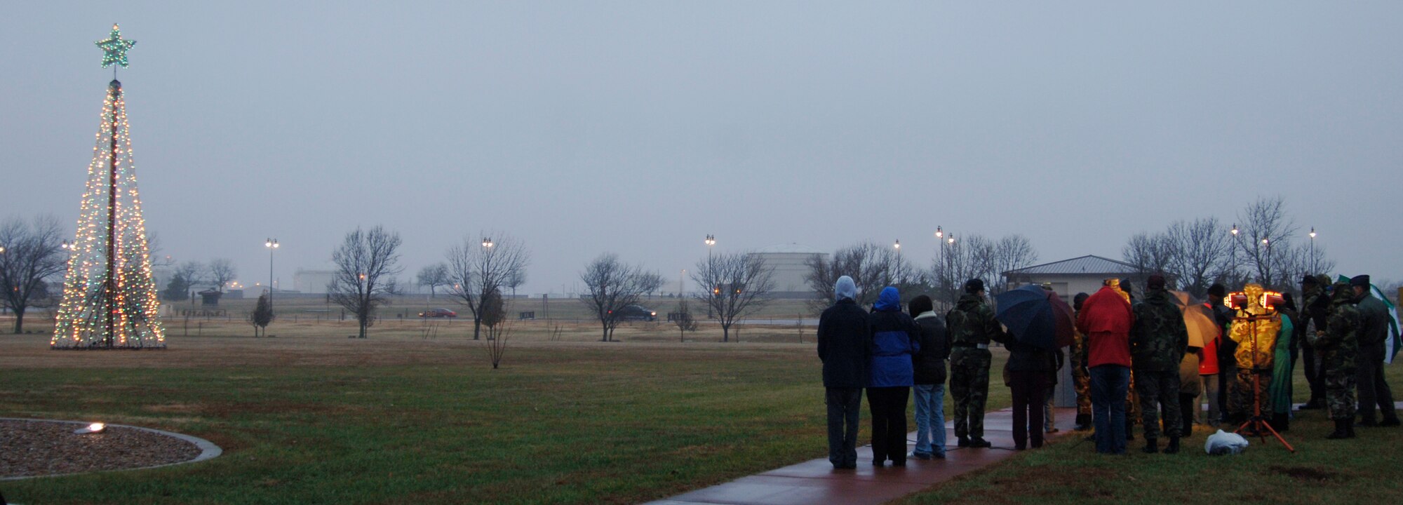 MCCONNELL AIR FORCE BASE, Kan. -- The holiday tree lighting ceremony participants gaze at the holiday tree before heading to the reception in the Chapel annex on Dec. 7. The holiday tree was lit by Col. John Zazworsky, and helping him was Allyson and Trenton McDonald whose father Staff Sgt. Terry McDonald, 22nd Operations Group, is currently deployed.  (Photo by Airman 1st Class Maria Ruiz)