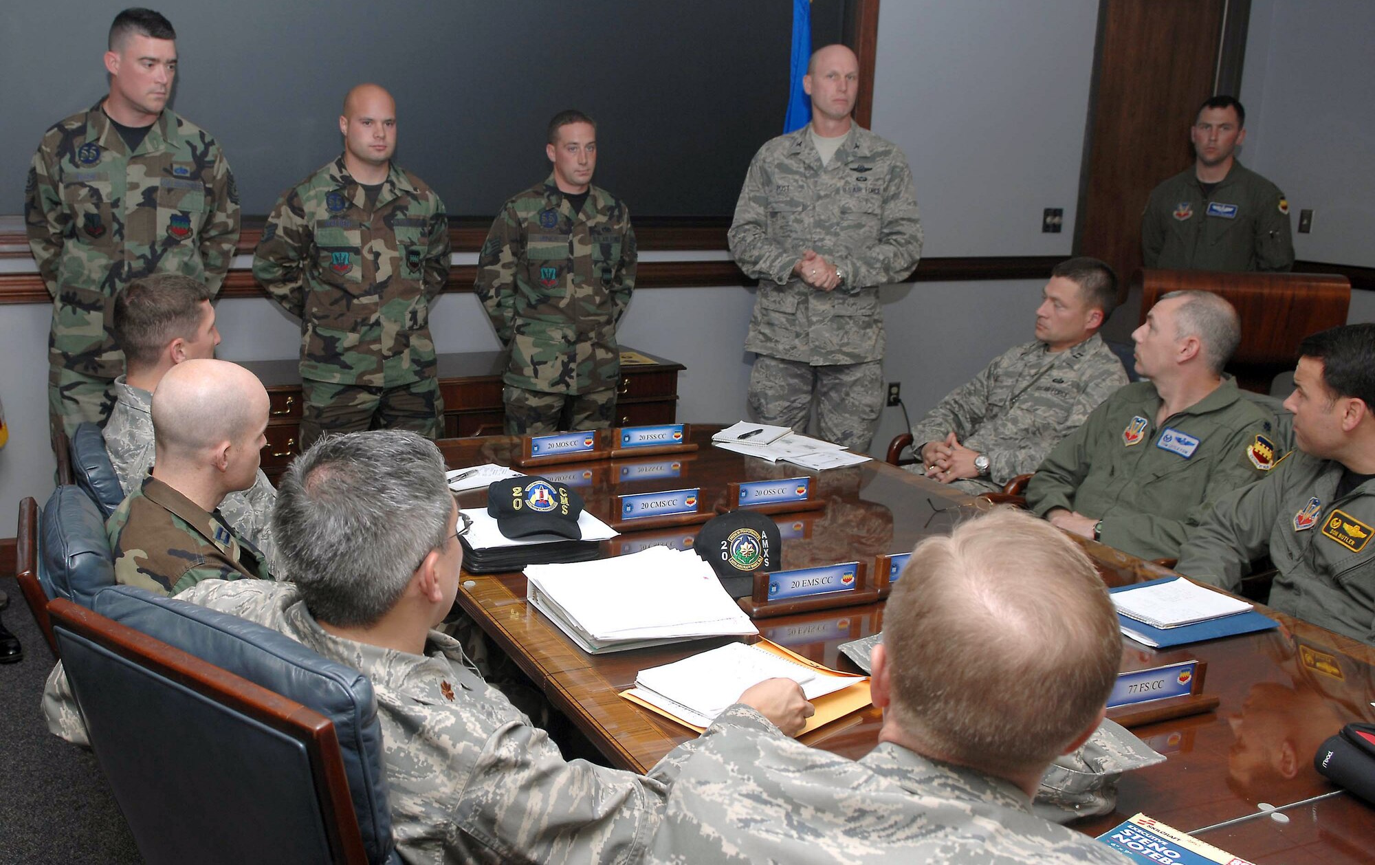 Col. James Post presents the Lt. Erwin Shaw Ace Award to crew chiefs (left to right) Tech. Sgt. Fredric Wilson, Staff Sgts. Lee Walden and Brad Miner,during a wing staff meeting Nov. 28. The sergeants earned the award for their quick and accurate emergency response to an aircraft fire. Colonel Post is the 20th Fighter Wing commander and the sergeants are with the 55th Aircraft Maintenance Unit. (U.S. Air Force photo/Airman 1st Class Matthew Davis)