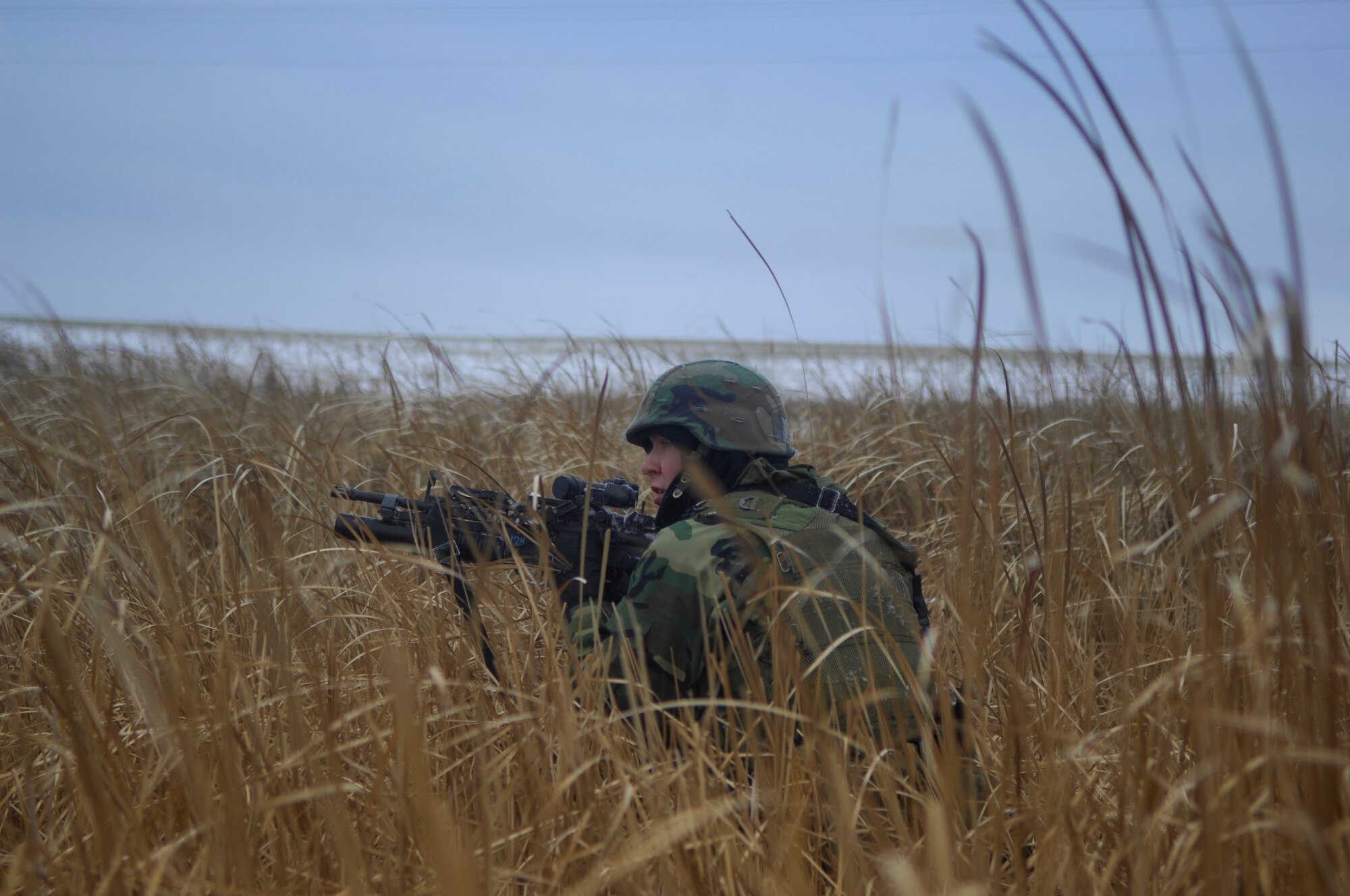 MINOT AIR FORCE BASE, N.D. – Senior Airman Joseph Taperman, 91st Missile Security Forces Squadron, maneuvers tactically through a field during a recap exercise at a Launch Facility Dec. 11. The recap exercise tests the 91 Security Forces Group’s Airmen on their ability to recapture control of a launch facility. (U.S. Air Force photo by Airman First Class Joe Rivera)