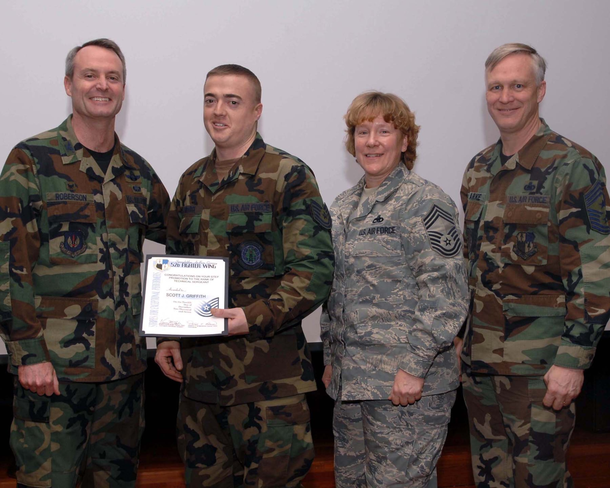 SPANGDAHLEM AIR BASE, Germany – Tech. Sgt. Scott Griffith, 52nd Communications Squadron, stands with Col. Darryl Roberson, 52nd Fighter Wing commander, Chief Master Sgt. Venetia Shaw, 52nd CS and Chief Master Sgt. Vance Clarke, 52nd FW command chief, after receiving news of his Stripes Through Exceptional Performance promotion Dec. 12, 2007. (U. S. Air Force photo/Airman 1st Class Allen Pollard)