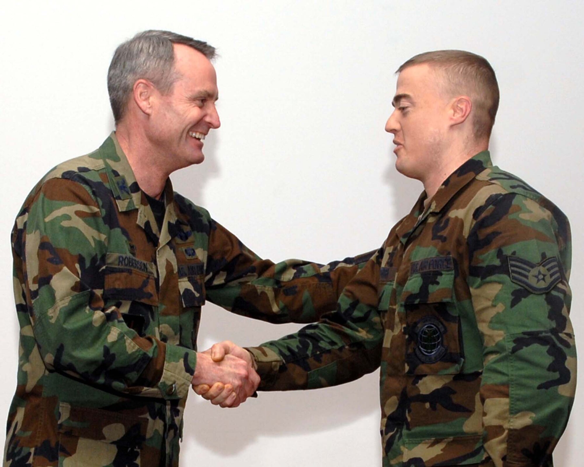 SPANGDAHLEM AIR BASE, Germany –Col. Darryl Roberson, 52nd Fighter Wing commander, congratulates Tech. Sgt. Scott Griffith, 52nd Communications Squadron, on his Stripes Through Exceptional Performance promotion Dec. 12, 2007. (U. S. Air Force photo/Airman 1st Class Allen Pollard)