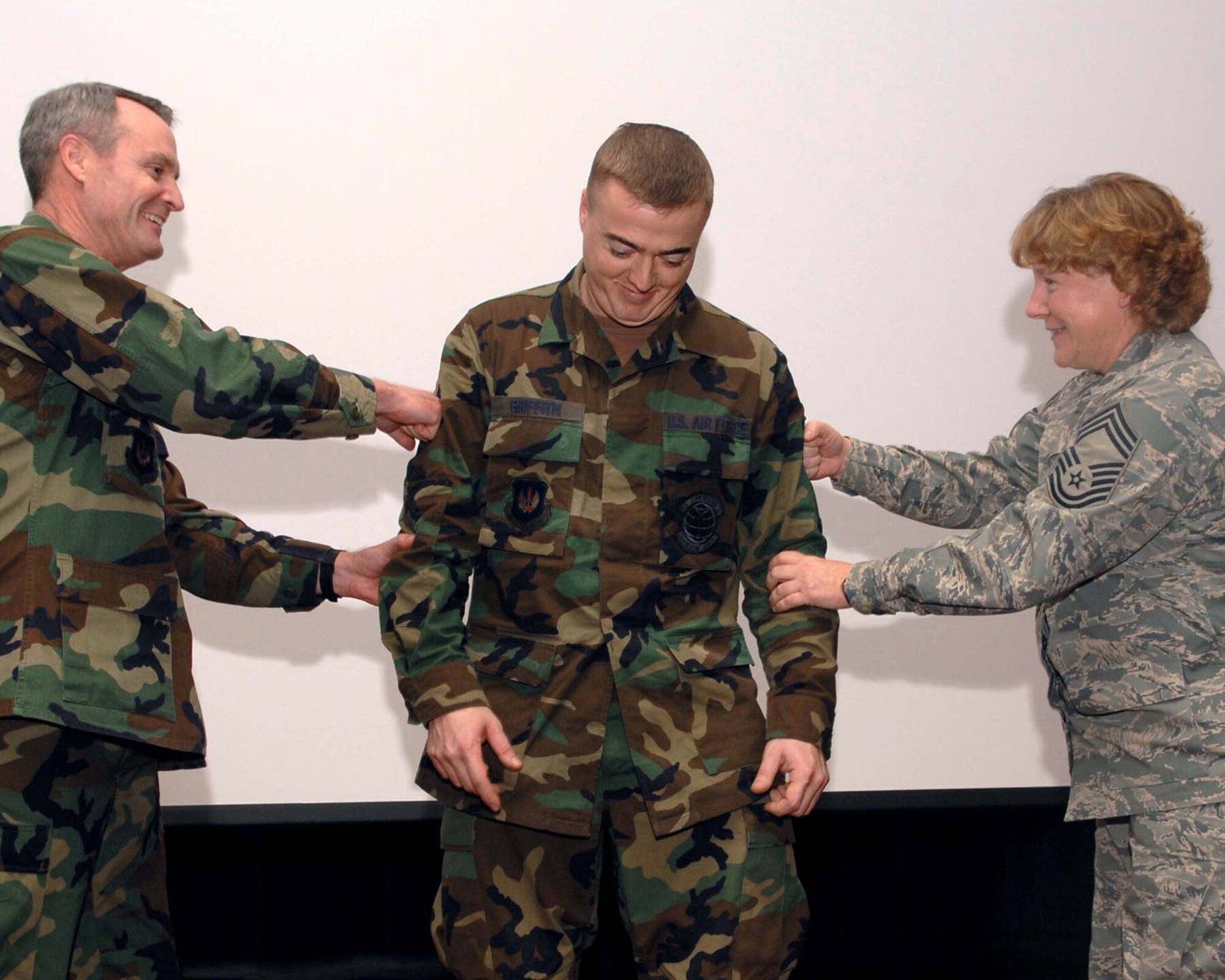 SPANGDAHLEM AIR BASE, Germany – Technical sergeant stripes are tacked on Scott Griffith, 52nd Communications Squadron, by Col. Darryl Roberson, 52nd Fighter Wing commander, and Chief Master Sgt. Venetia Shaw, 52nd CS. Sergeant Griffith was promoted Dec. 12, 2007, through the Stripes Through Exceptional Performance program. (U. S. Air Force photo/Airman 1st Class Allen Pollard)