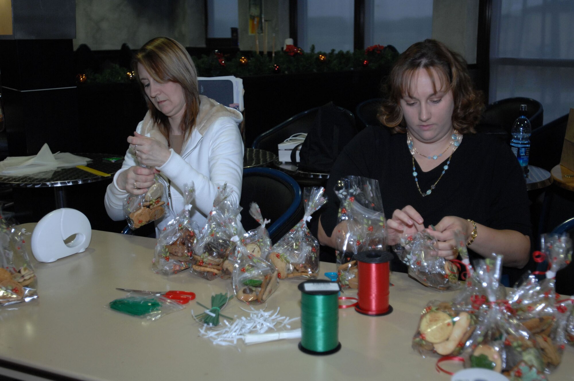 SPANGDAHLEM AIR BASE, Germany -- Biggi Piper, a volunteer, and April Miller, Officers Civilian Spouses Club, seal bags of fresh baked cookies at Club Eifel Dec. 12, 2007. The preparation for this year’s cookie drive started two months in advance. (U.S. Air Force photo/Airman 1st Class Jenifer Calhoun)