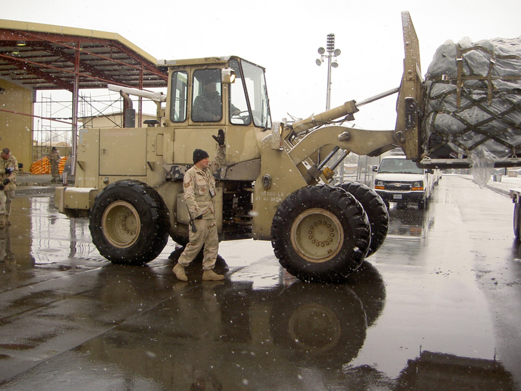 MANAS AIR BASE, Kyrgyzstan -- Drivers with vehicle operations perform a variety of tasks to include loading baggage pallets. Reservists with the 916th Logistics Readiness Squadron are currently deployed to Manas till 2008.